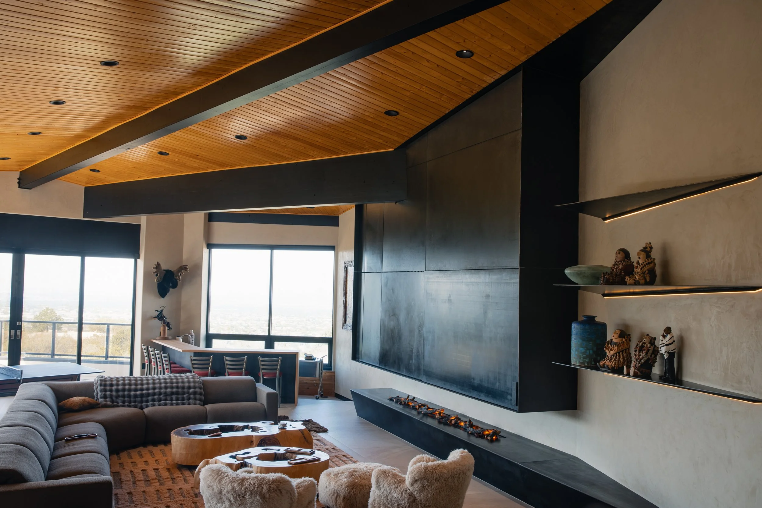 Custom fireplace, shelving, tv enclosure, built-in seating, doors, lighting and baseboards