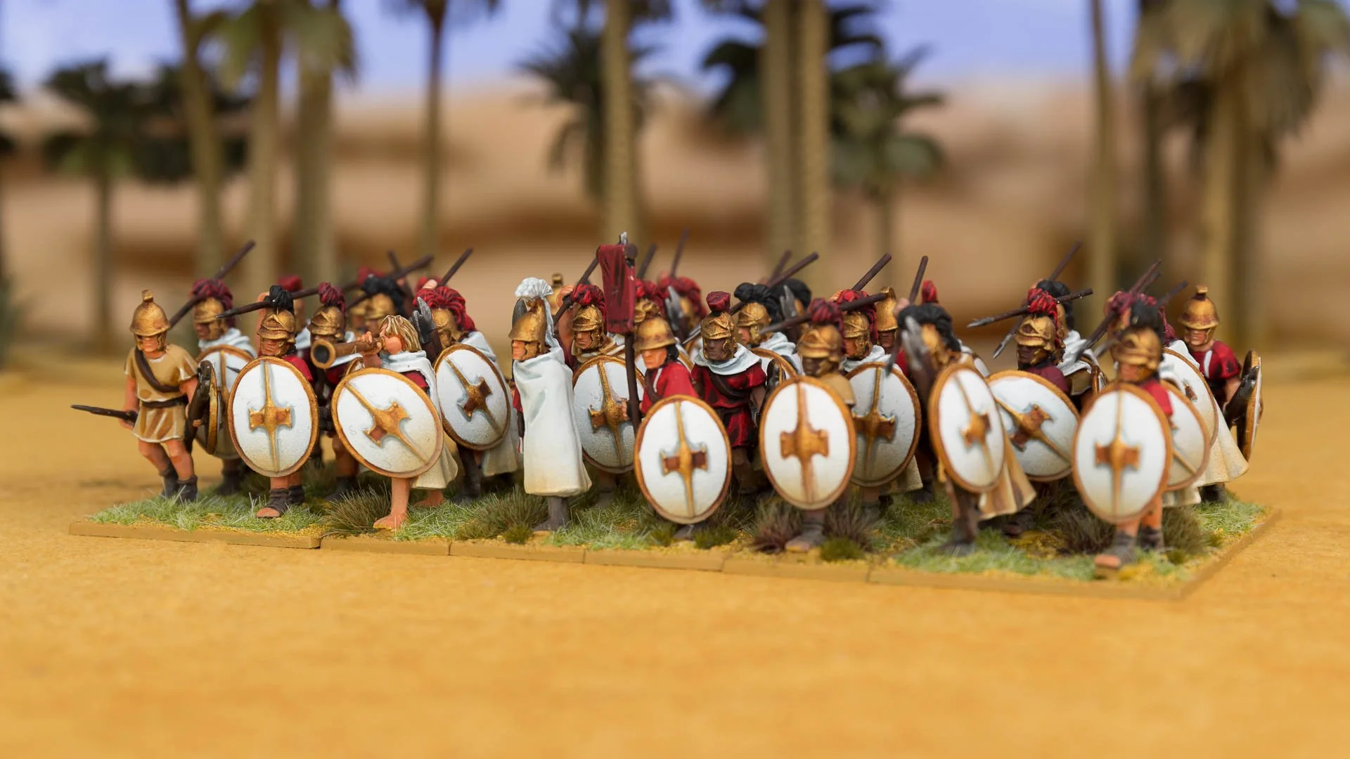 Regiment of painted miniature Ptolemaic infantry soldiers wielding spears and white oval shields.