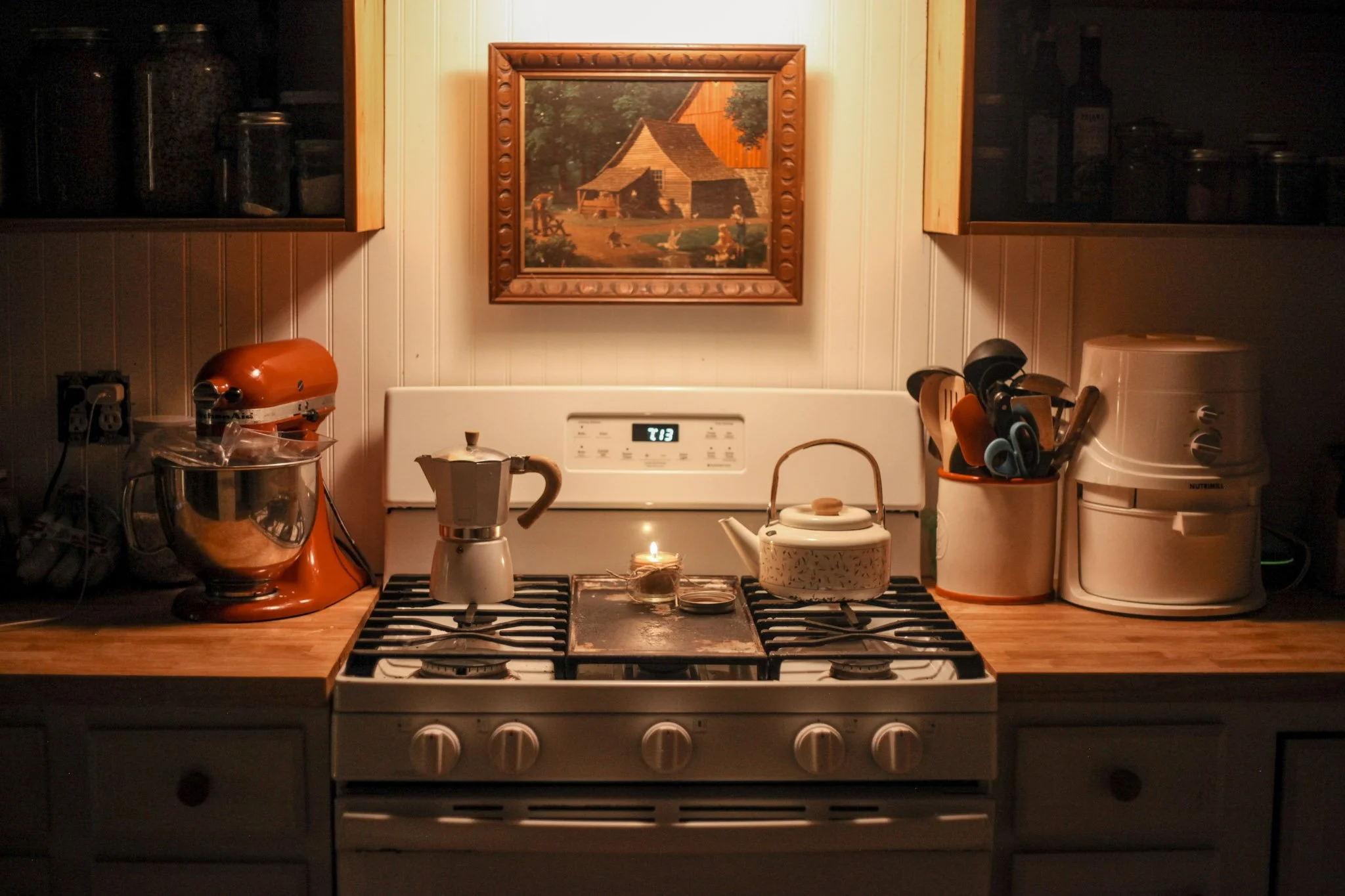 a kitchen is the early morning lit by a small beeswax candle