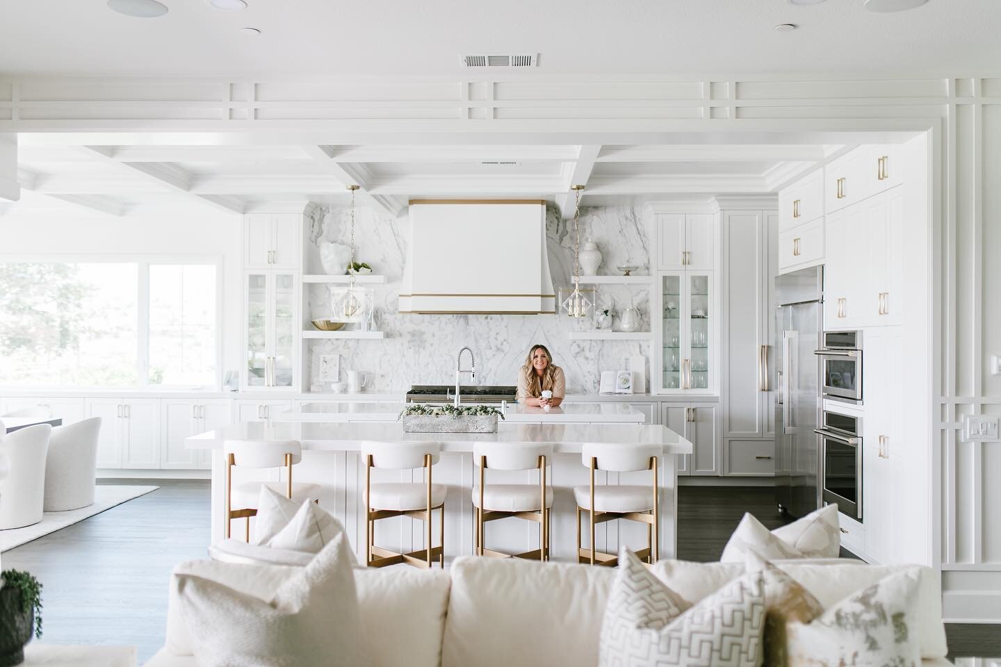 Believe it or not, this was a cosmetic remodel. We kept the integrity of the original kitchen and changed the backsplash, hood and wall cabinets. We soften the ceilings with a coffered ceiling treatment, added new light fixtures and chairs.