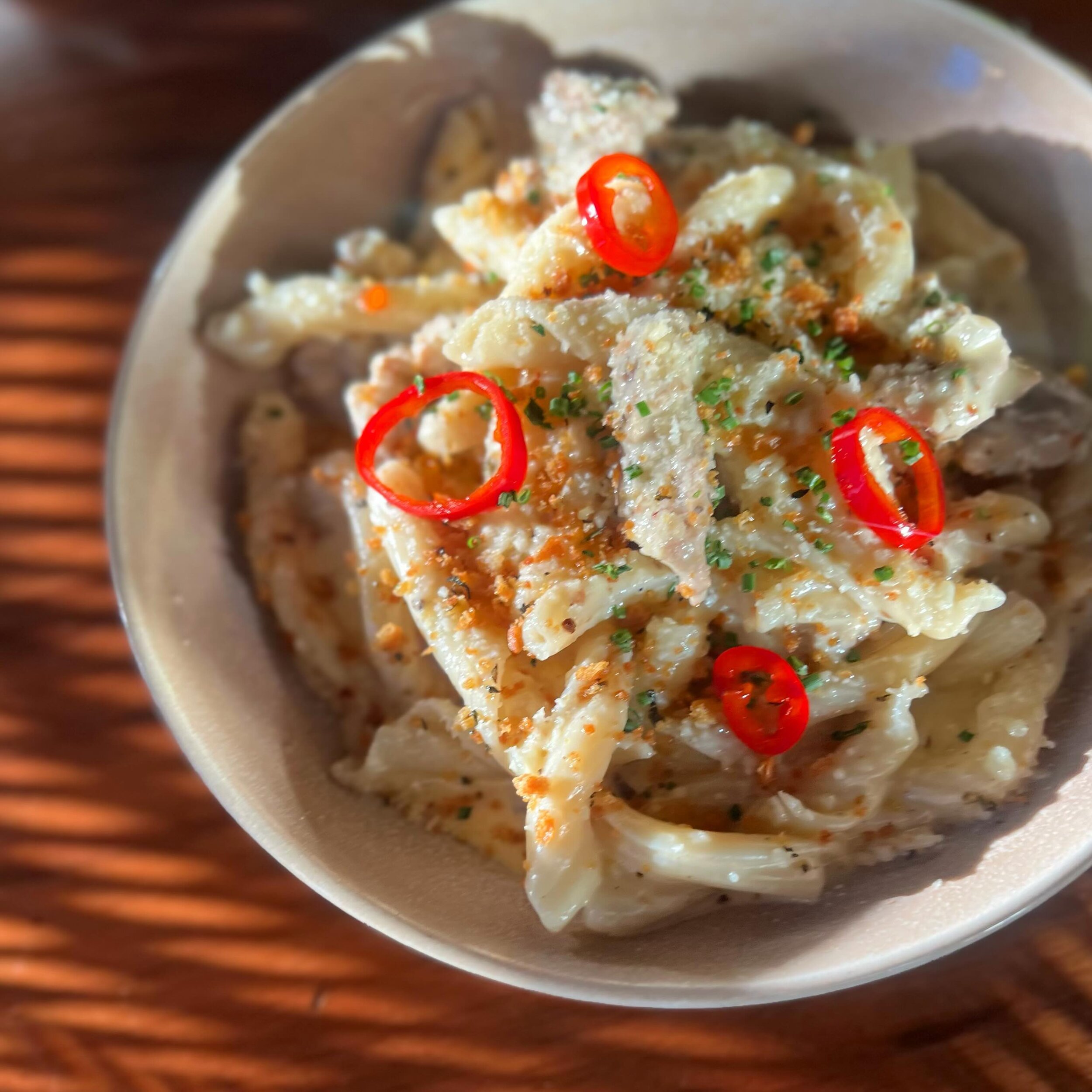 Pasta alla Norcina - one of our newest pastas is a fan favorite right out of the gate. Garganelli pasta and savory fennel sausage tossed in a black truffle parmesan cream sauce, finished with herbed bread crumbs and a few pickled Fresnos for a pop of