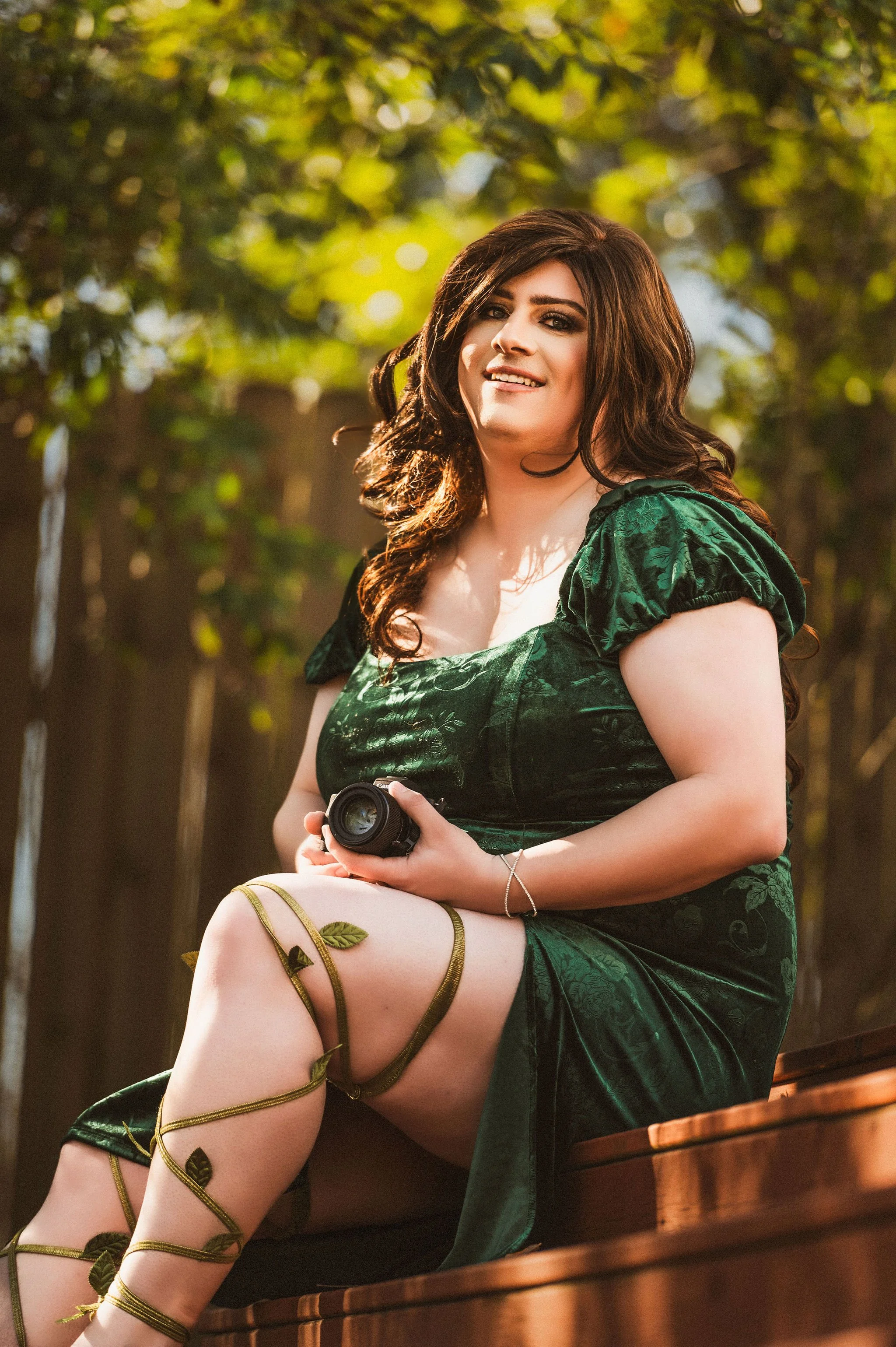 Trans woman poses at My Boudoir Atlanta for beauty portrait outdoors with camera.