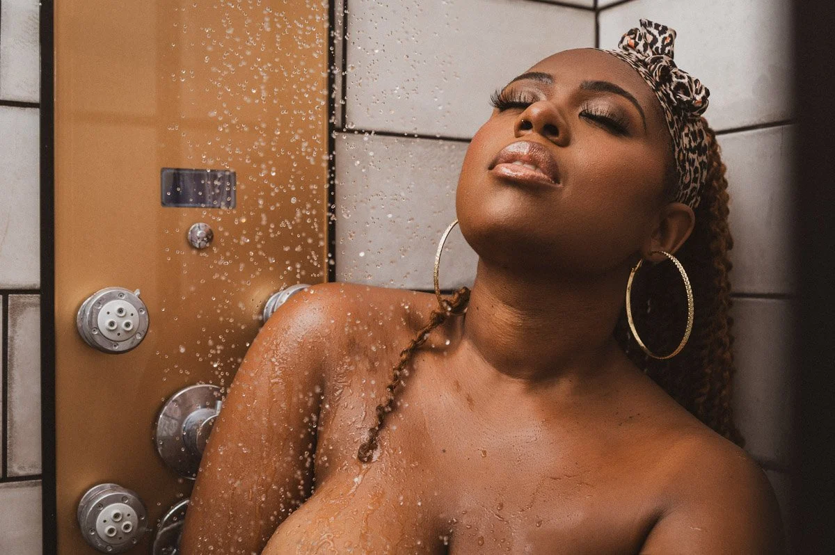 Curvy Atlanta woman poses for Kaia at My Boudoir Atlanta in a shower to embrace body positivity.