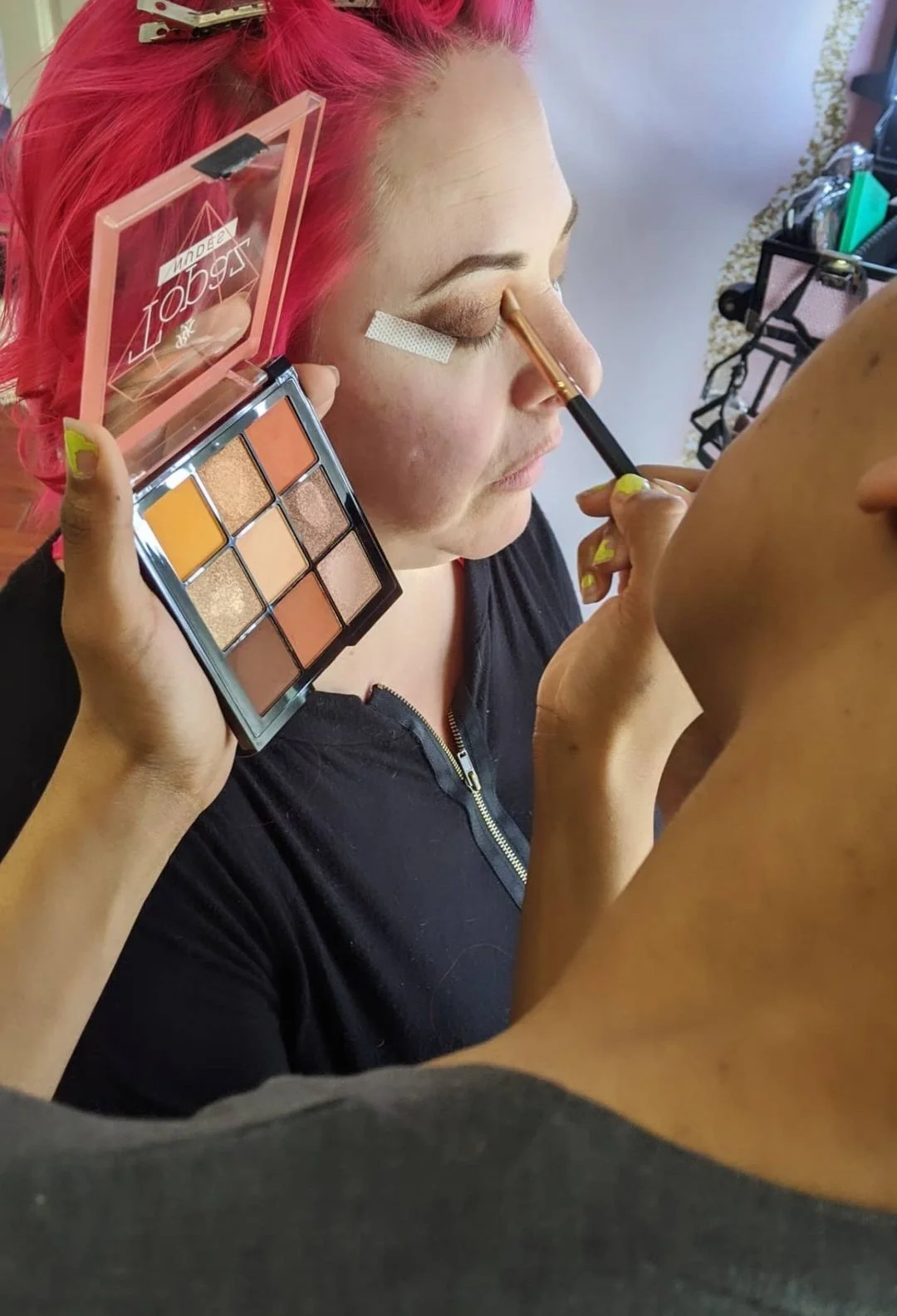 Woman with pink hair gets professional makeup done at My Boudoir Atlanta.