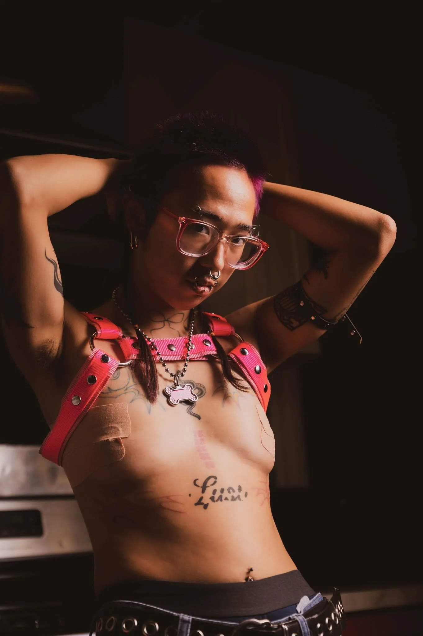 Young non binary Asian trans person poses at My Boudoir Atlanta.