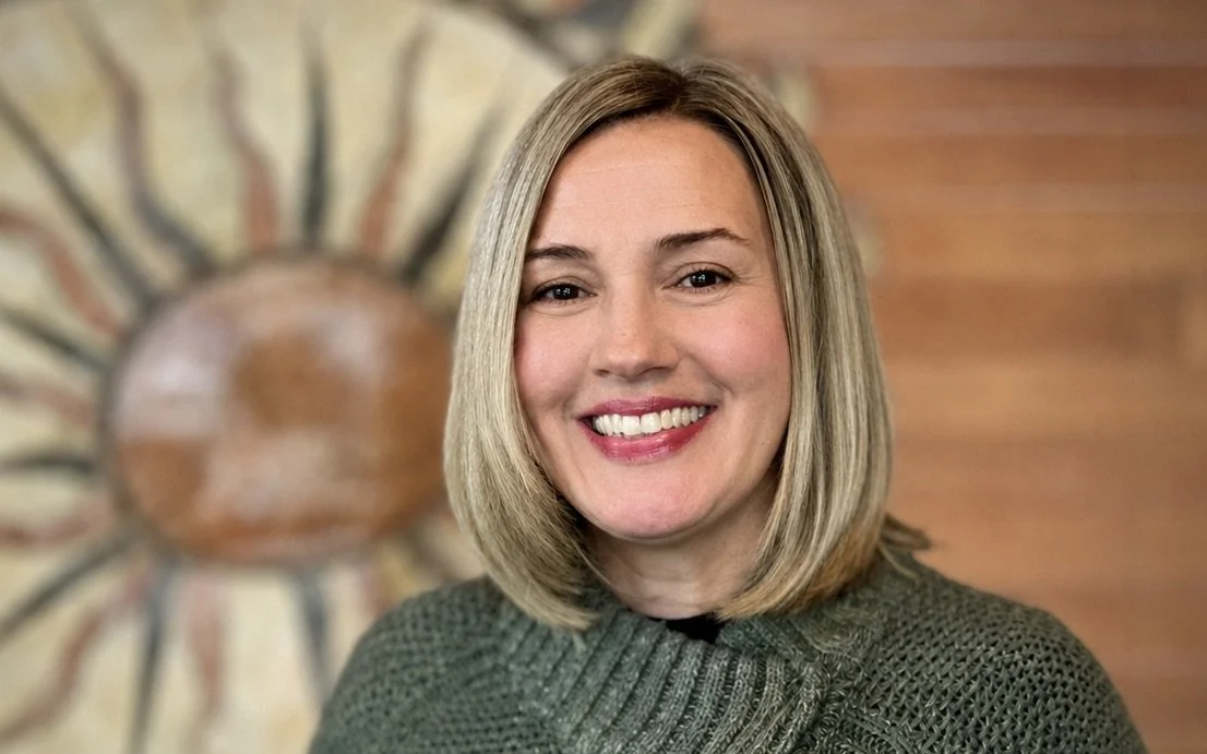 Smiling blond woman with green sweater