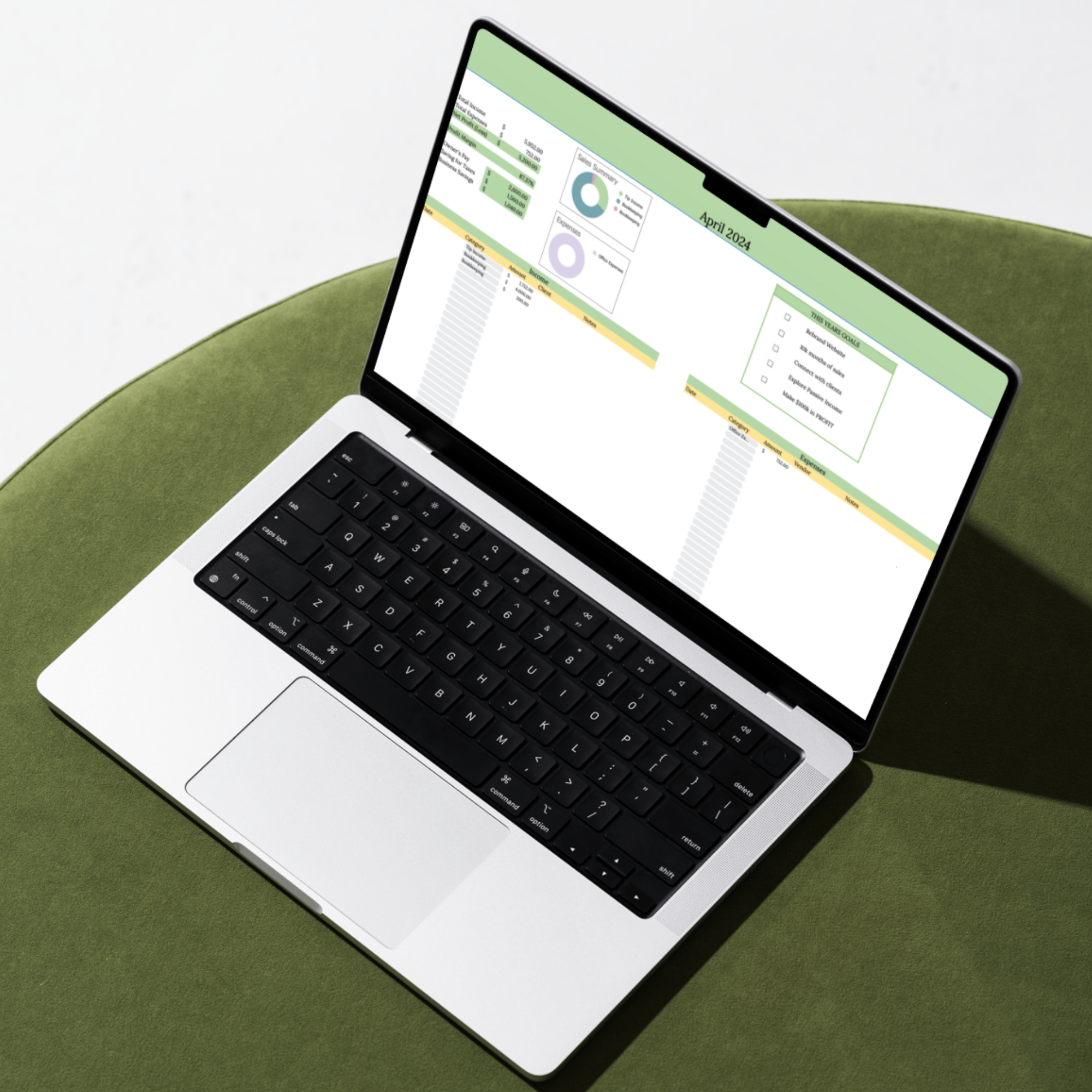 Laptop displaying a financial planning spreadsheet on a green chair from Carefully Counted.