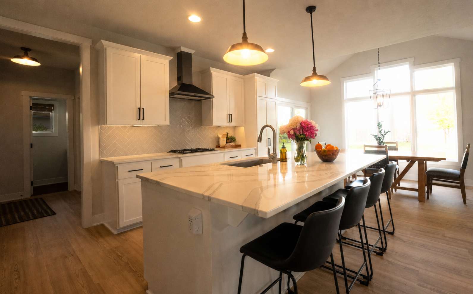 Unedited handheld photo of a white kitchen with island, showing blown-out windows and uncorrected lighting