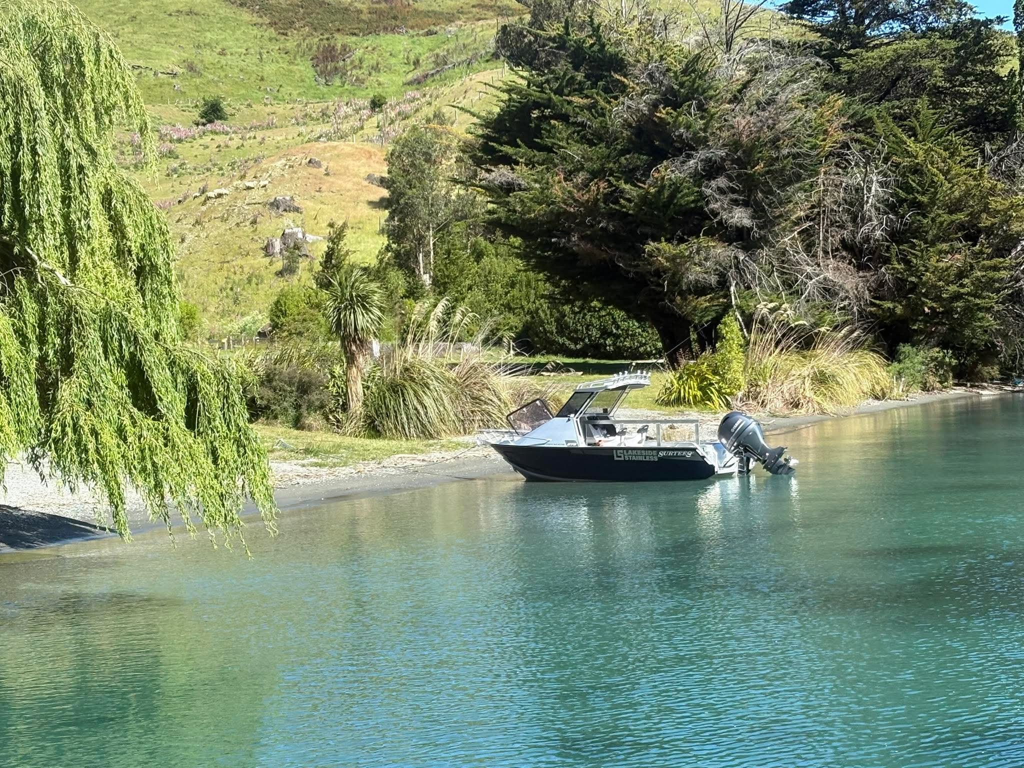 Stainless steel contractor accessing lakefront property by boat in Queenstown