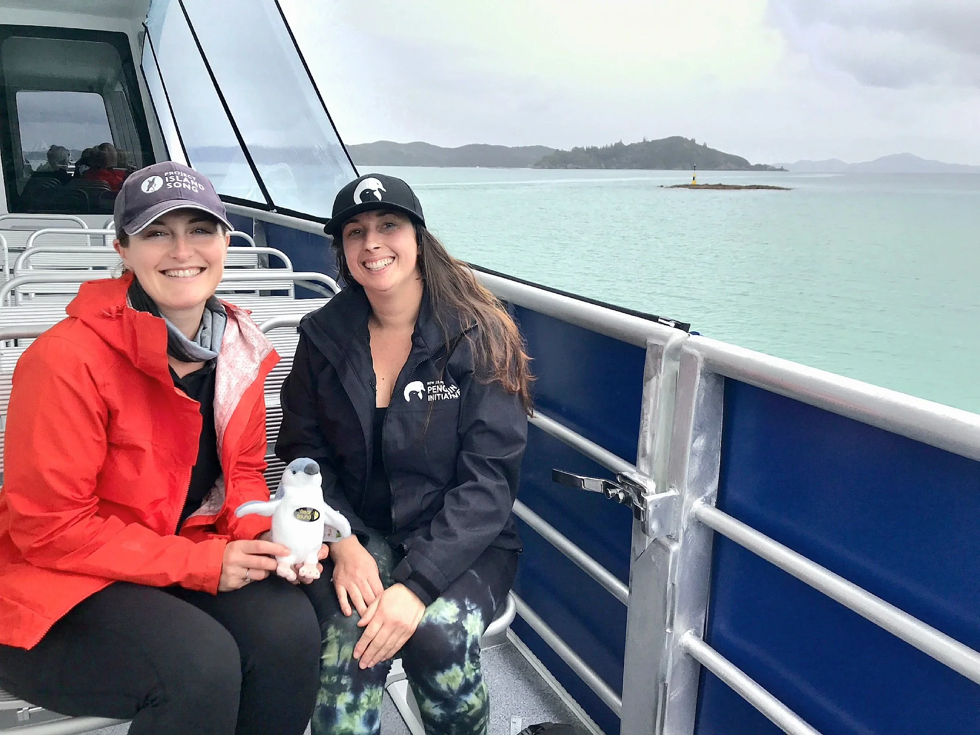 Laura from Project Island Song and Community Programme Manager travel via ferry to survey kororā habitat on Urupukapuka Island. Image Credit: A. O'Neill