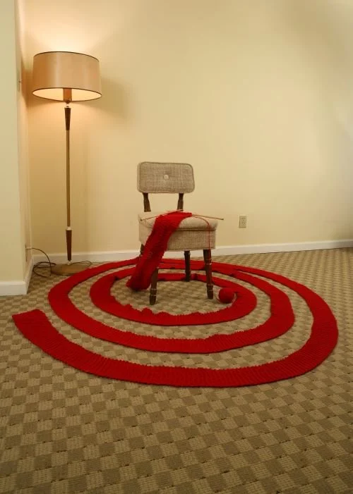"Knitting Meditation for Peace," 2010, vintage chair, yarn, knitting needles and lampstand, ephemeral performance documentation.