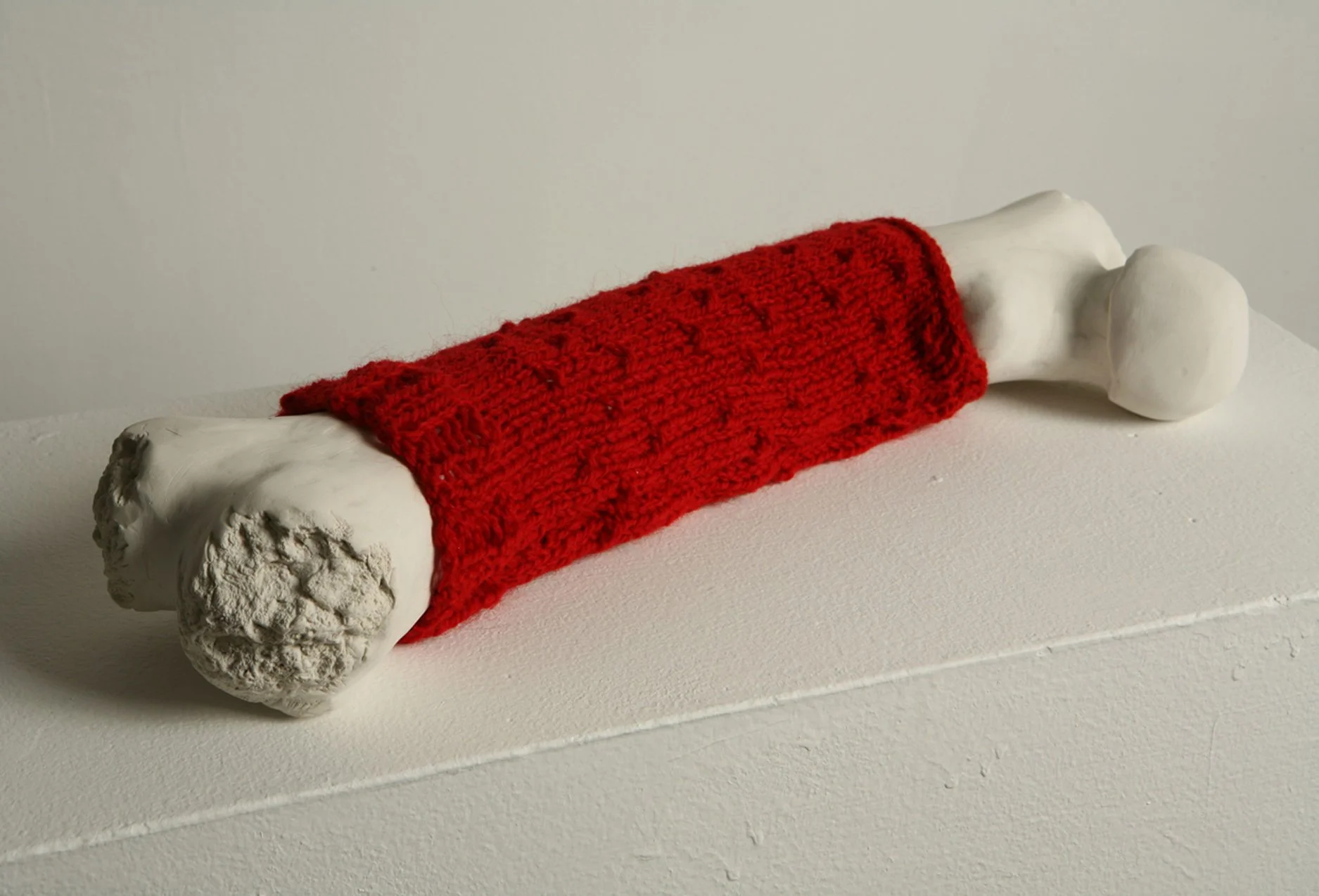 "Boneknit," 2009, ovenbaked clay and handknit cozy, 3 x 19 x 4 inches