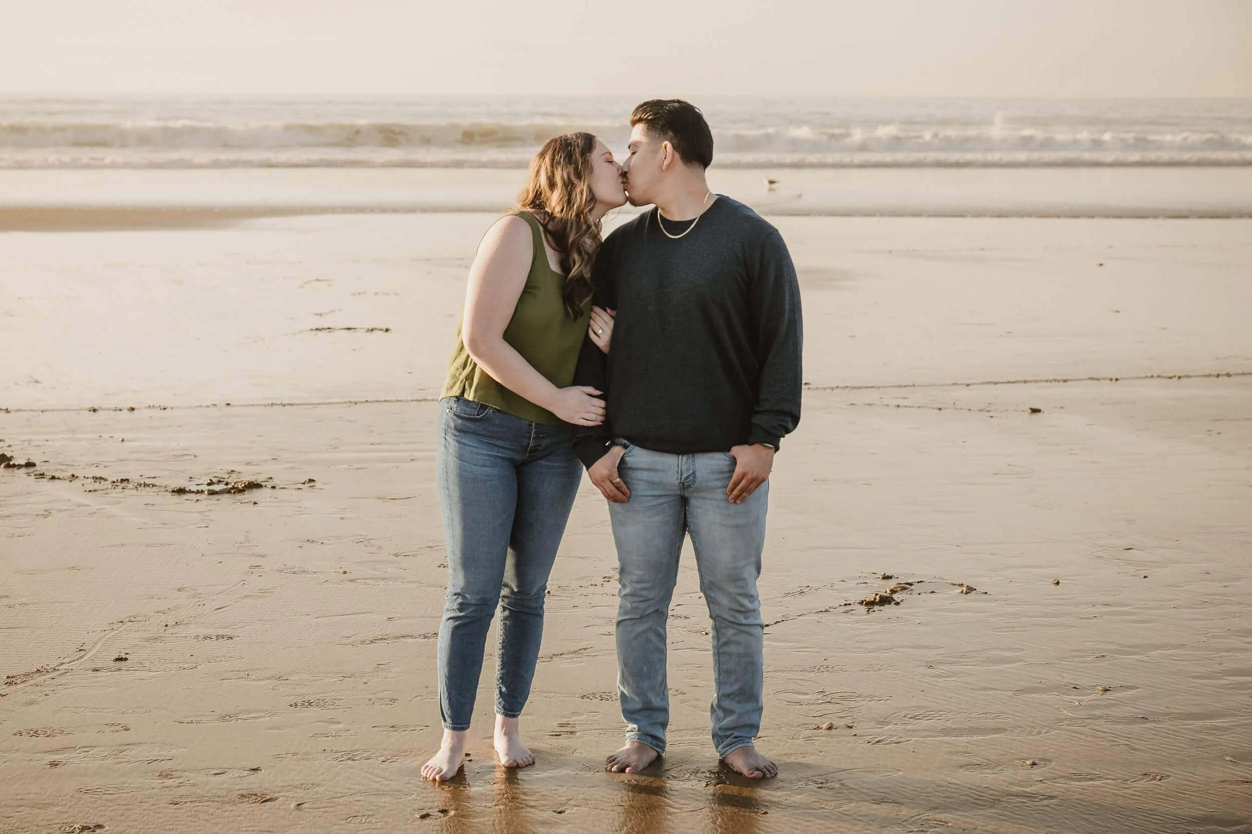 Couple kissing during La Jolla Shores and Scripps Pier Family Photography in San Diego