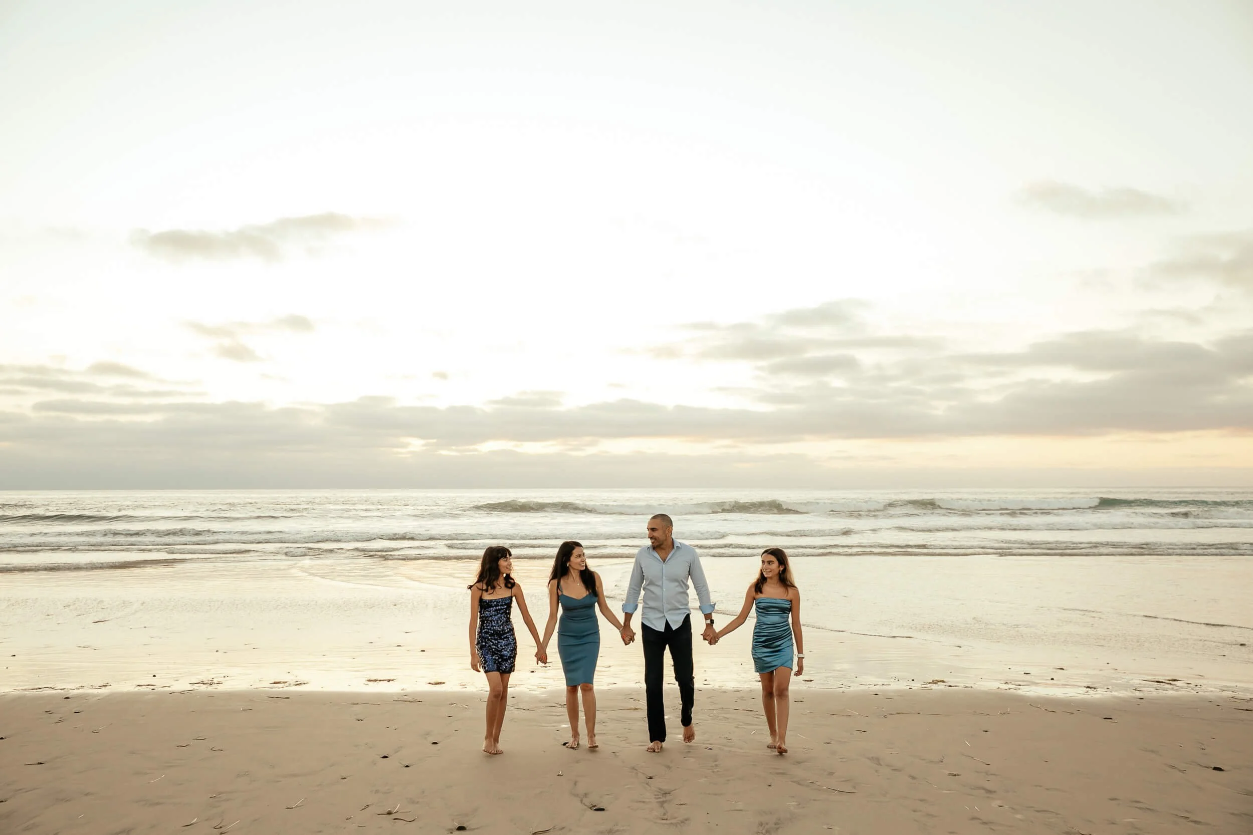 Family walking together by the ocean during a Carlsbad Beach Family Photography Session