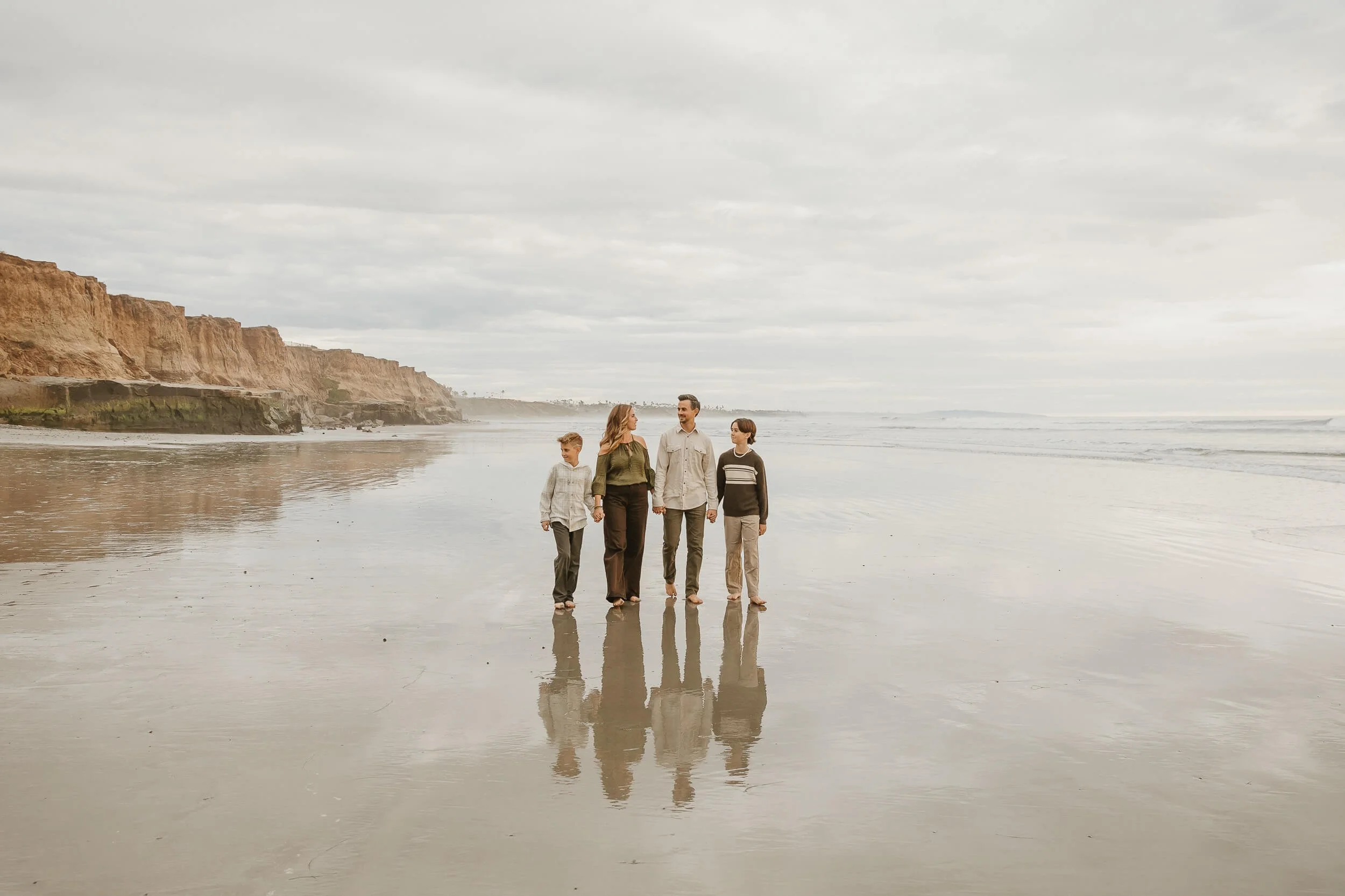 Candid beach family portrait during golden hour in Southern California