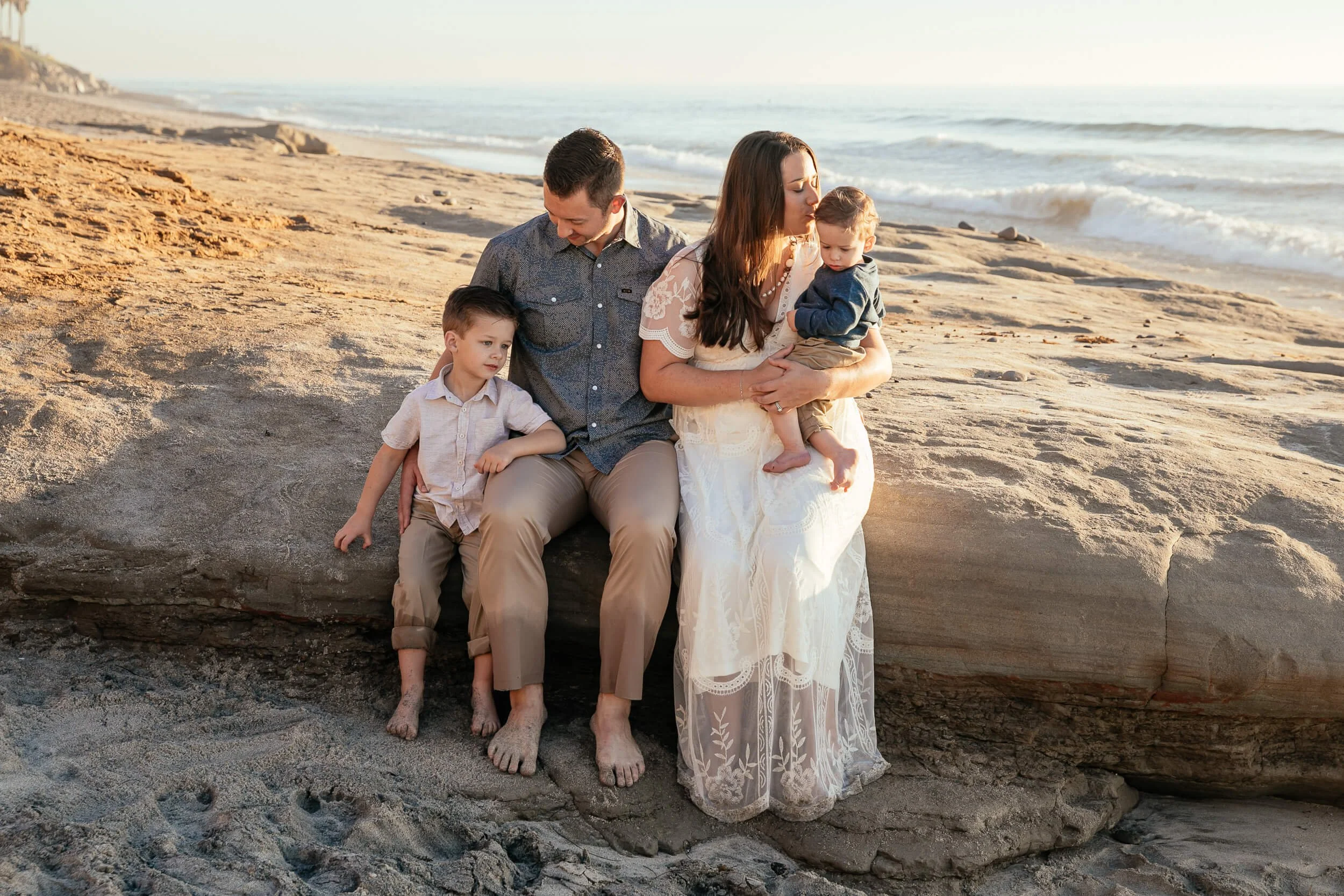 Parents with children during a sunset beach family photography session photographed by a Carlsbad wedding photographer
