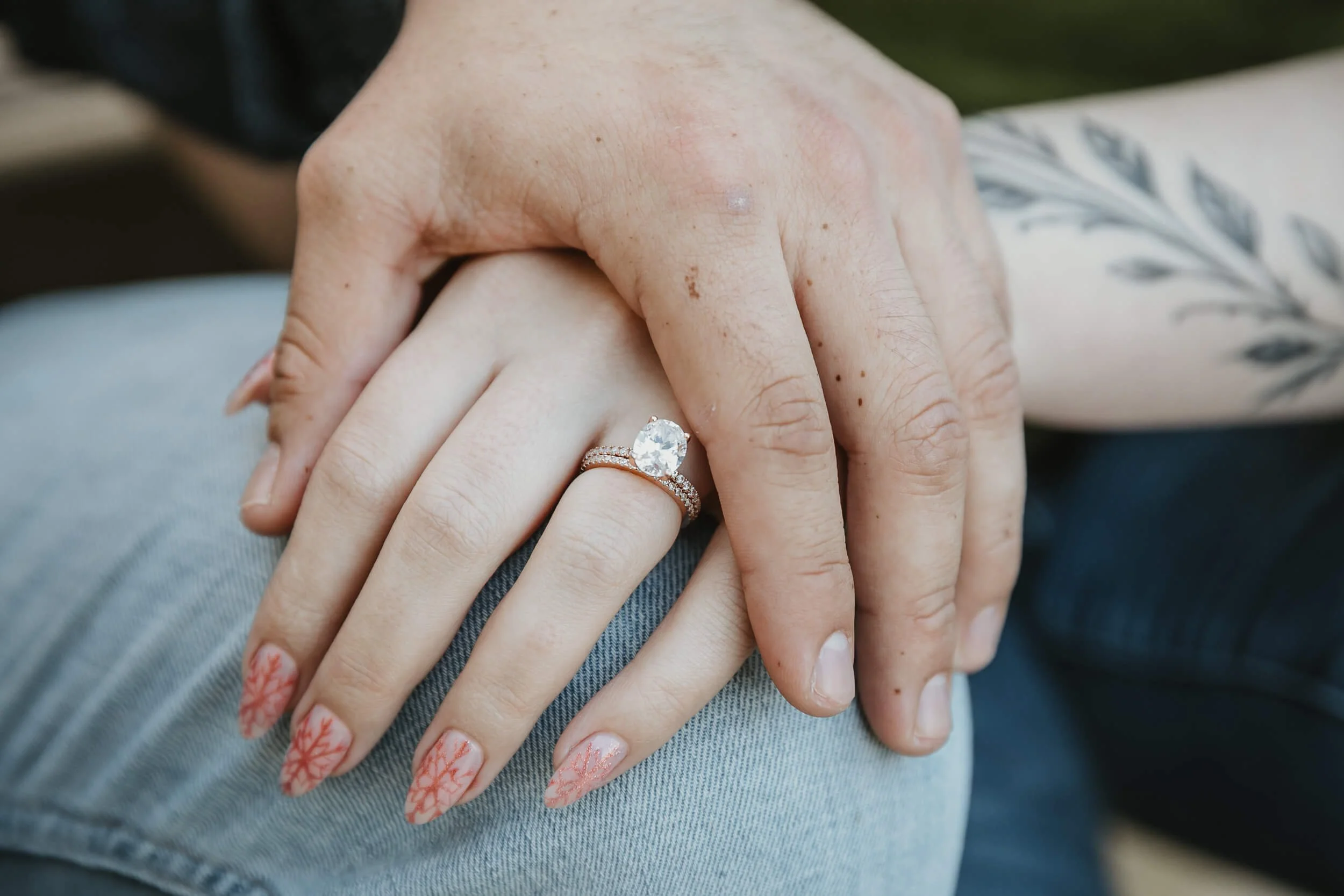 Closeup of bride and groom to be hands focusing on her engagement ring for La Jolla Shores session