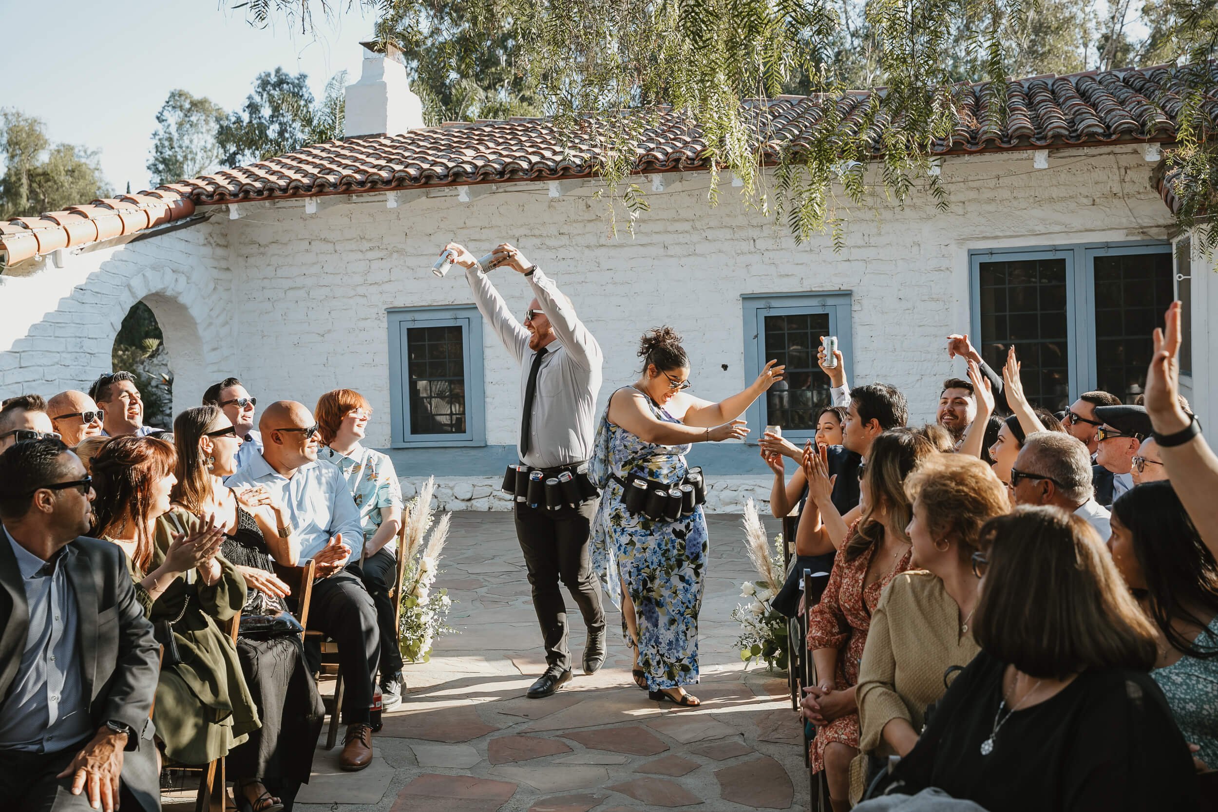 Fun, candid moment guests receiving beer before the ceremony at Leo Carillo Ranch Wedding