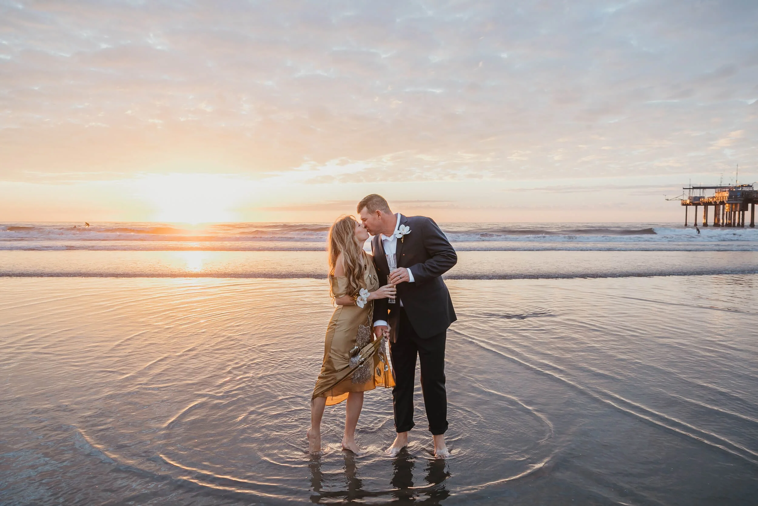 Couple kissing during the sunset golden hour La Jolla Shores and Scripps Pier Family Photography in San Diego