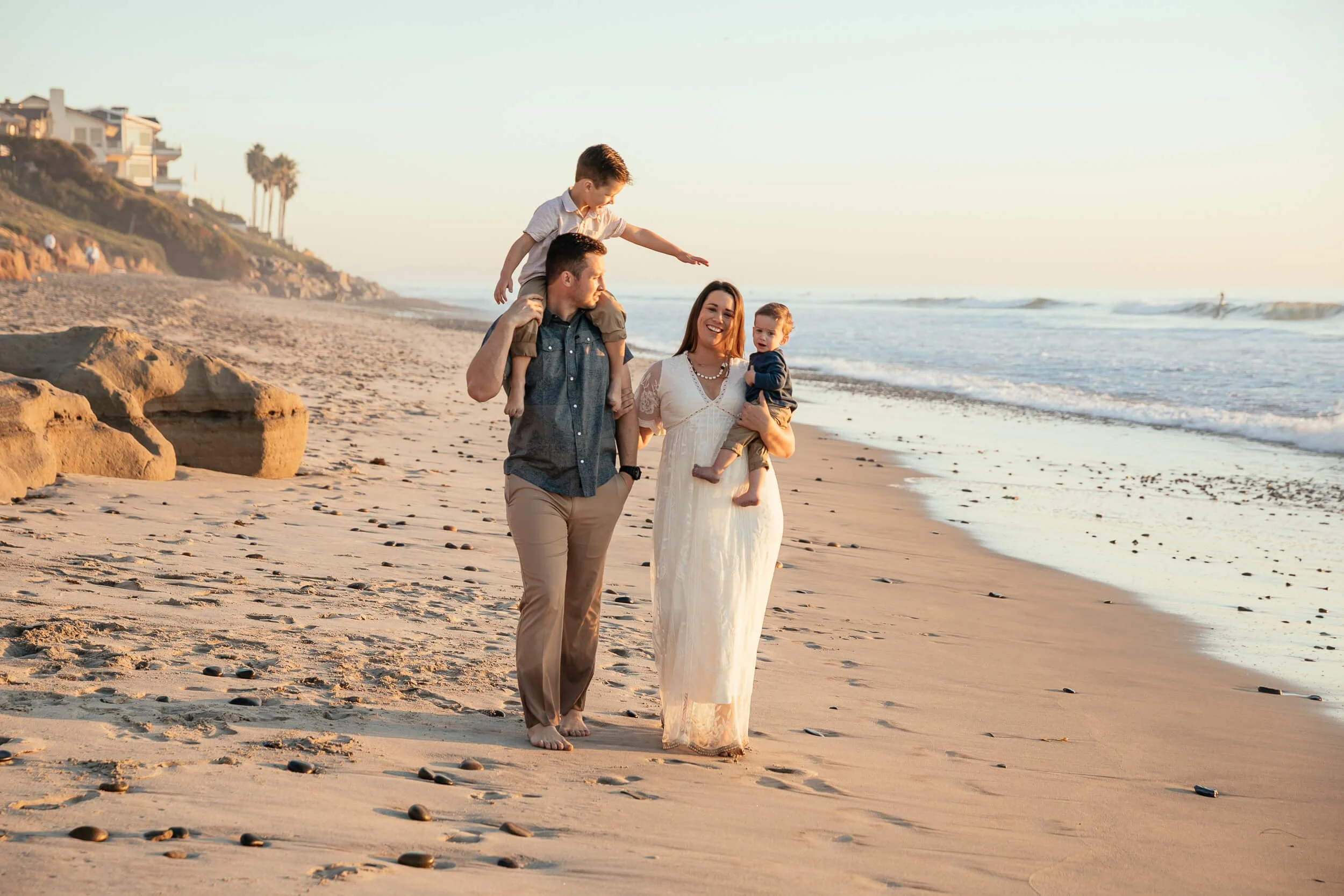 Family walking along the shoreline during a Carlsbad Beach Family Photography Session