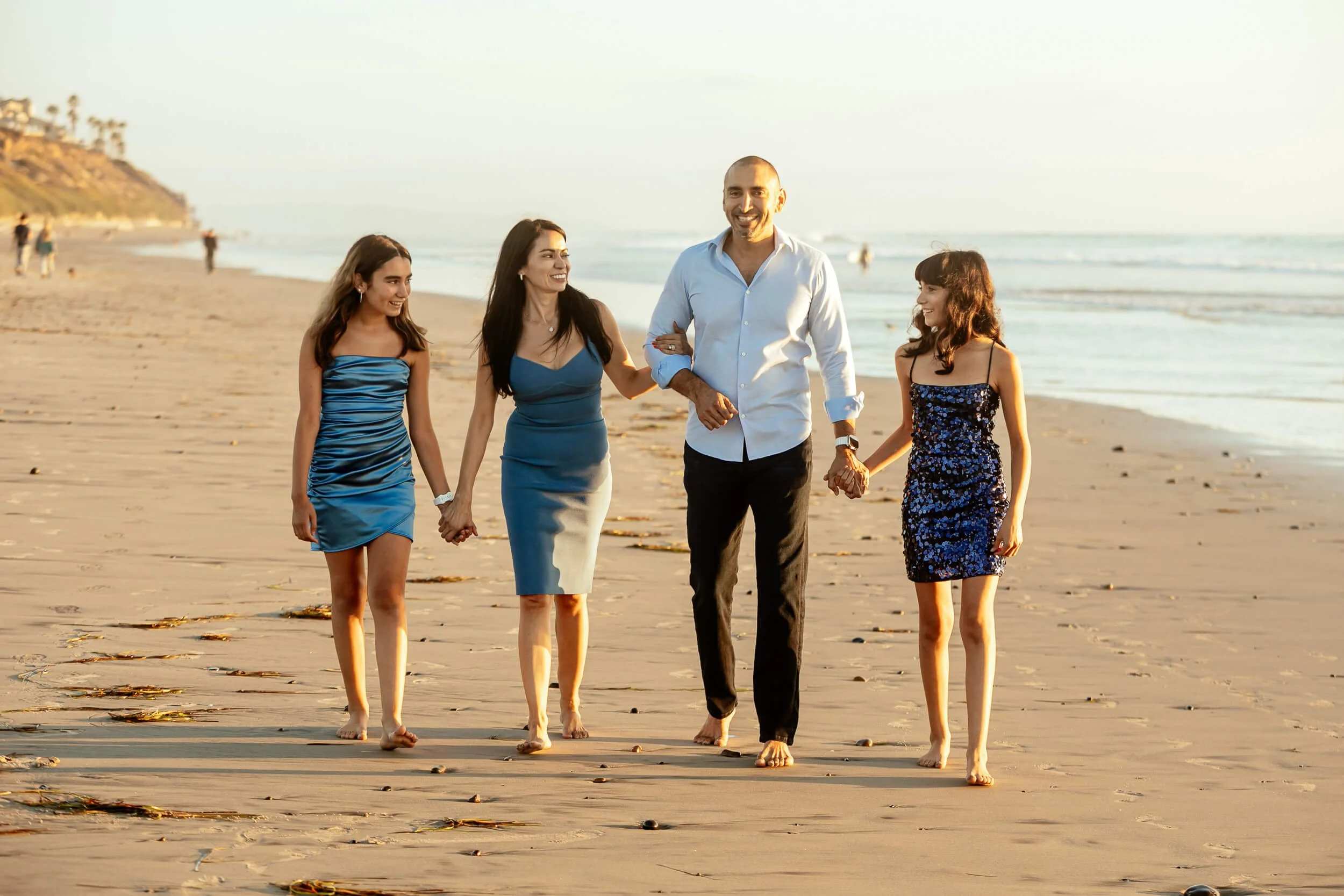 Family walking together on the shoreline during a Carlsbad Beach Family Photography Session