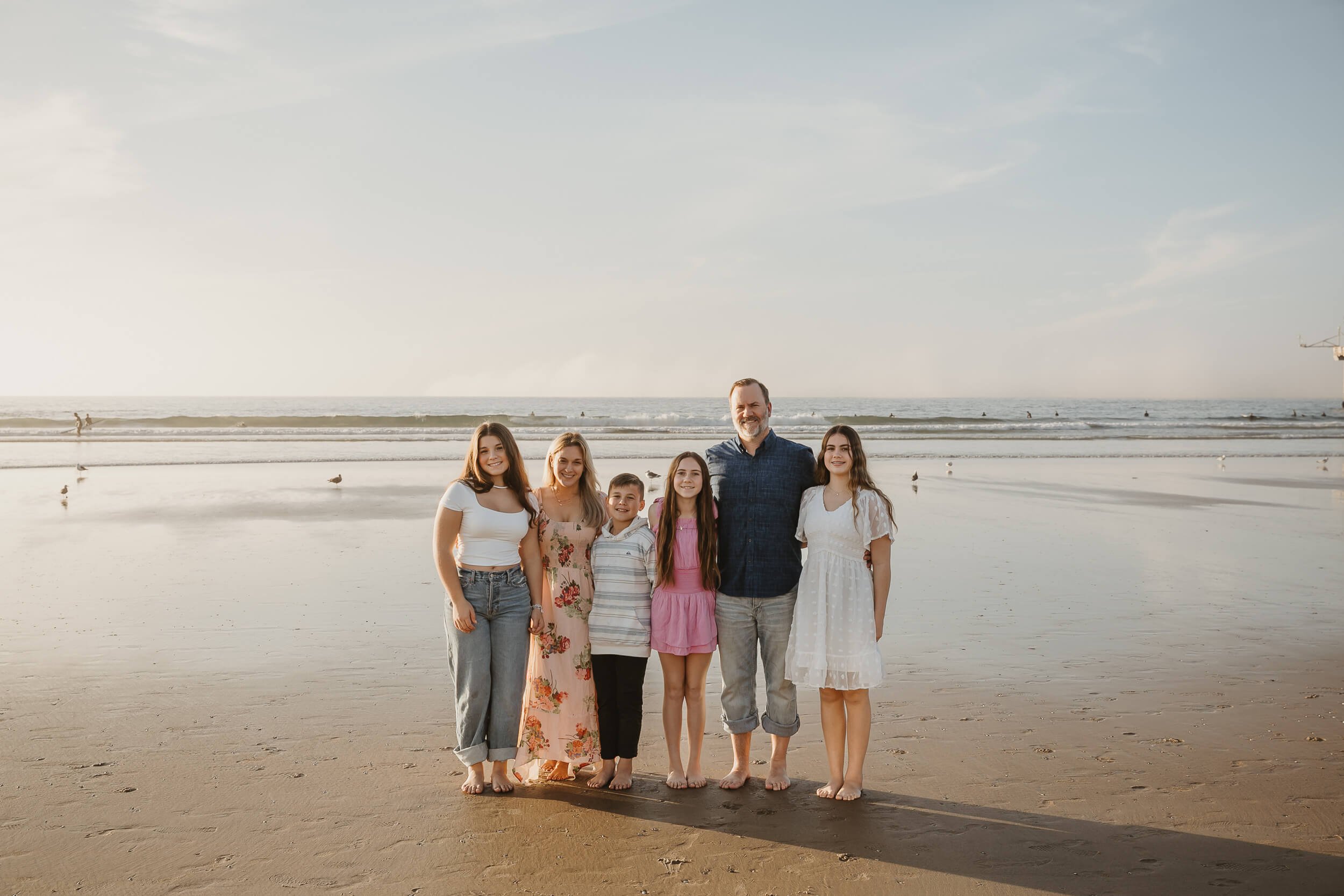 Family of six posing for photos during San Diego mini session in La Jolla Shores and Scripps Pier
