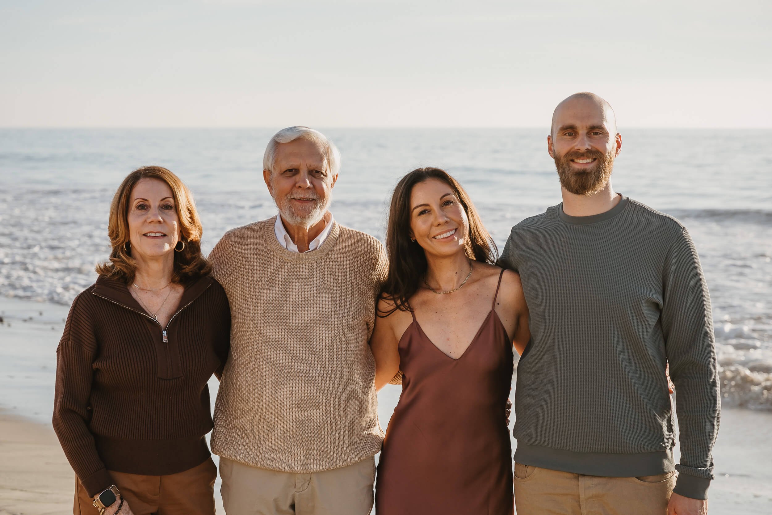 Natural family portrait at the beach photographed by a Carlsbad wedding photographer