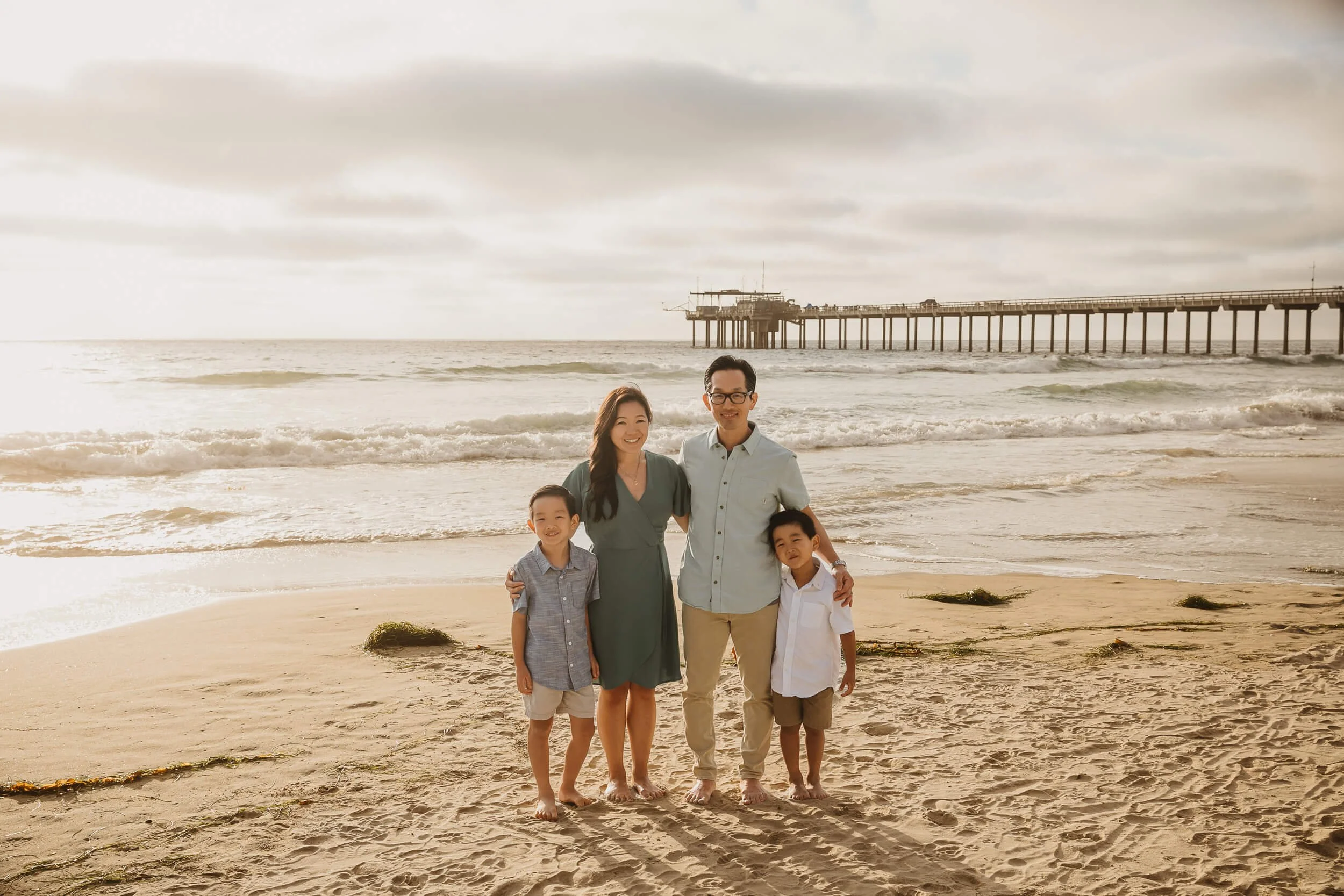 Parents and children posing at La Jolla Shores and Scripps Pier Family Photography in San Diego