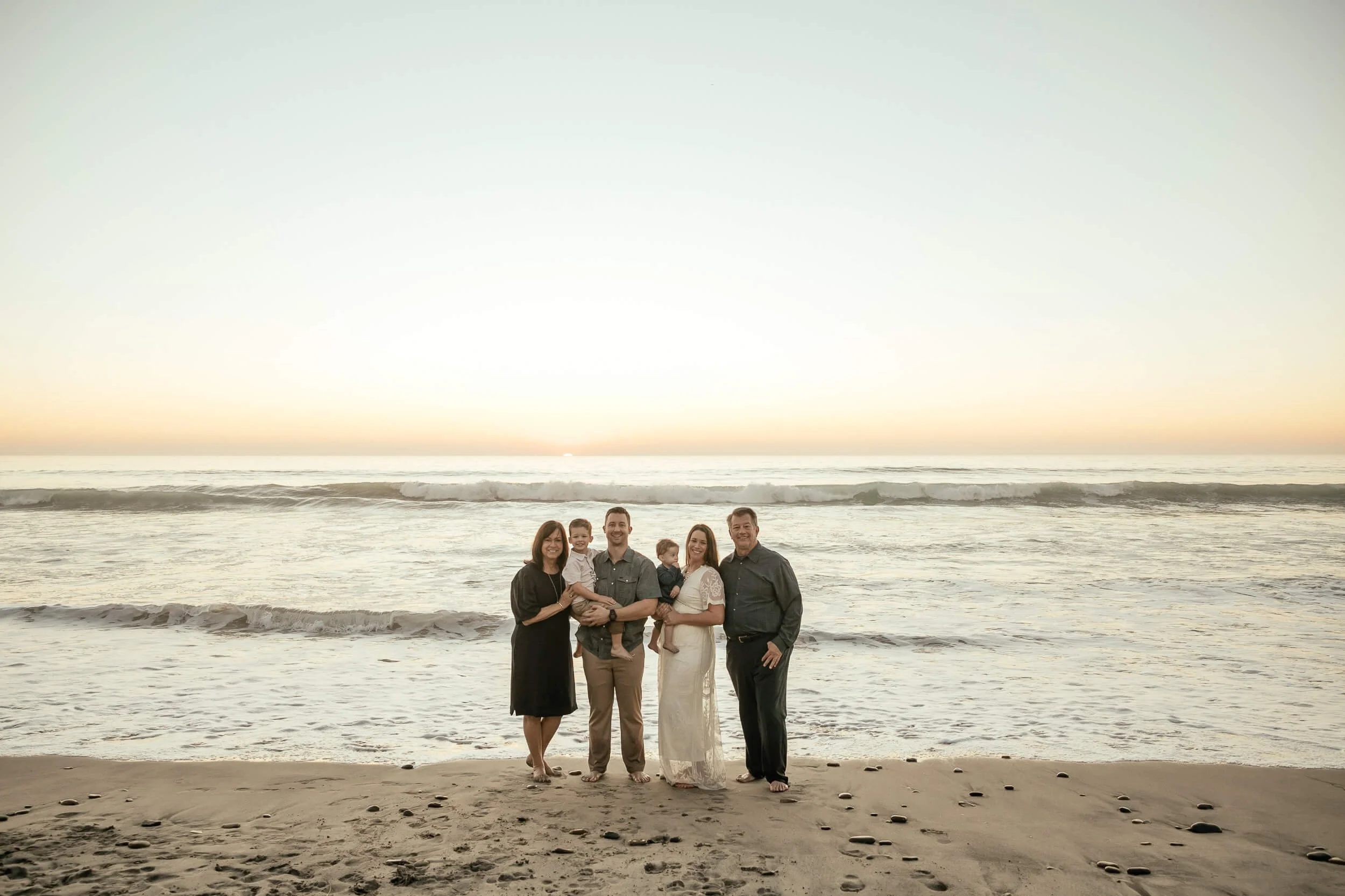 Wide beach family portrait during sunset in Carlsbad, California