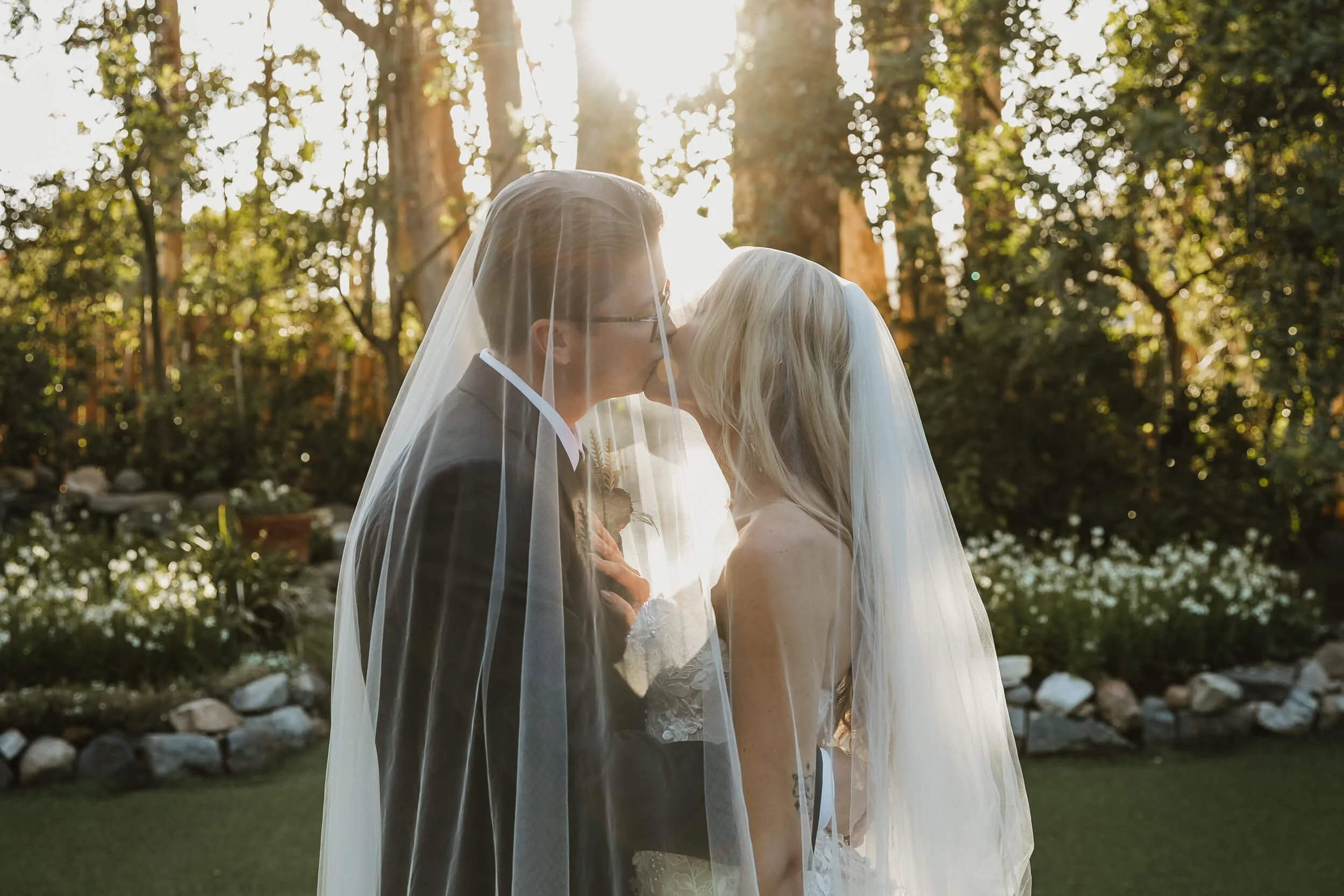 Bride and groom kissing under veil at Twin Oaks House & Gardens Estate Wedding in San Diego
