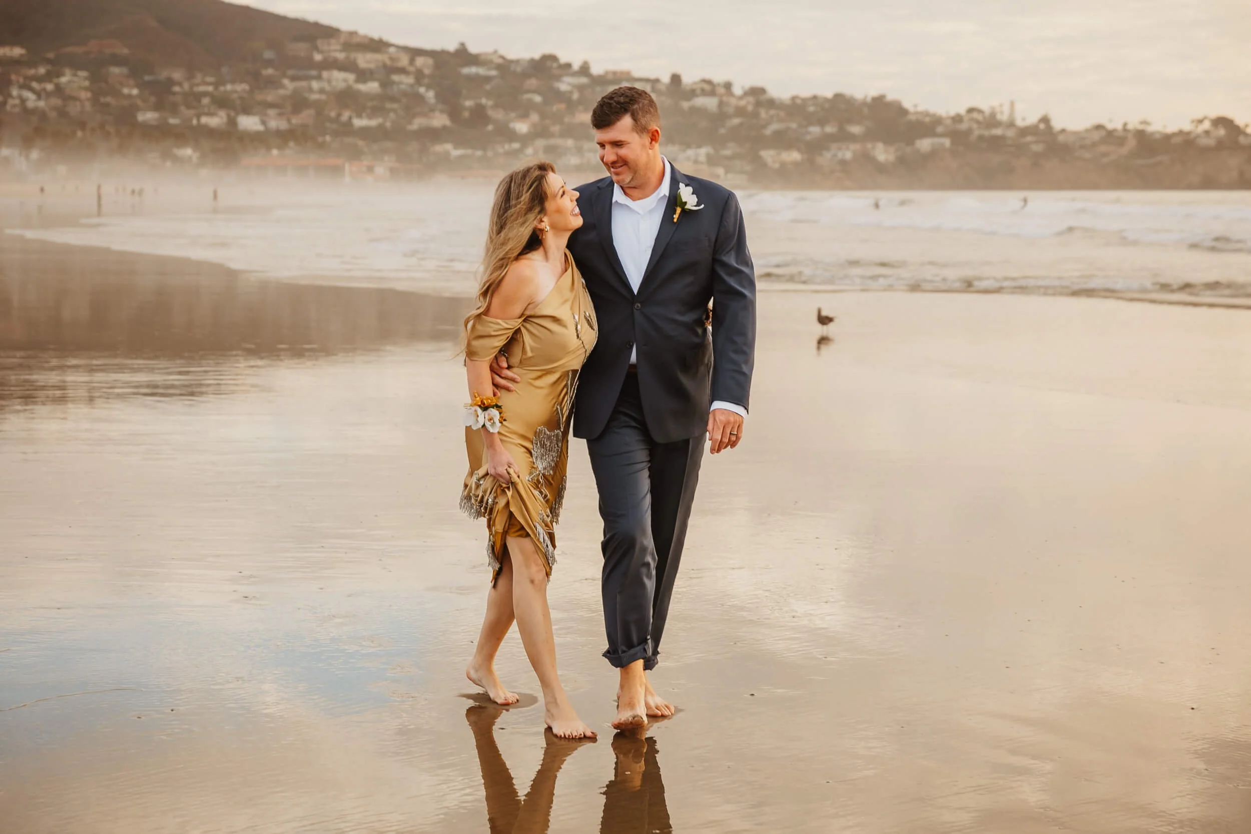 Closeup couple walking together and looking at each other during La Jolla Shores and Scripps Pier Family Photography in San Diego