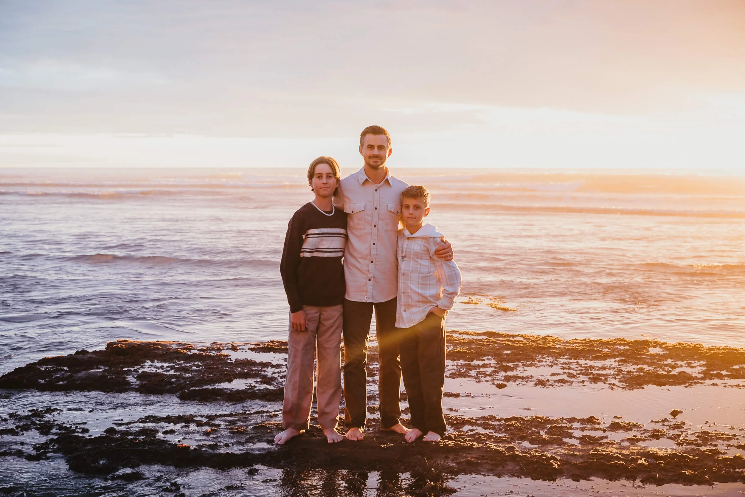 Family portrait by the ocean during golden hour in Carlsbad, California