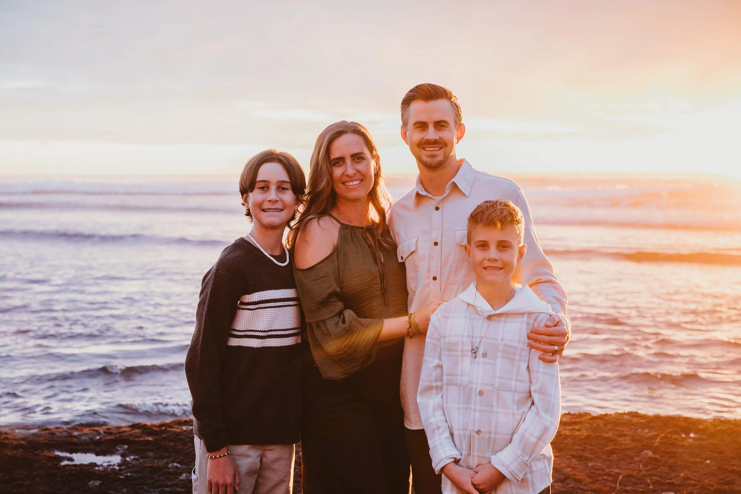 Close-up family beach portrait photographed at sunset by a Carlsbad wedding photographer