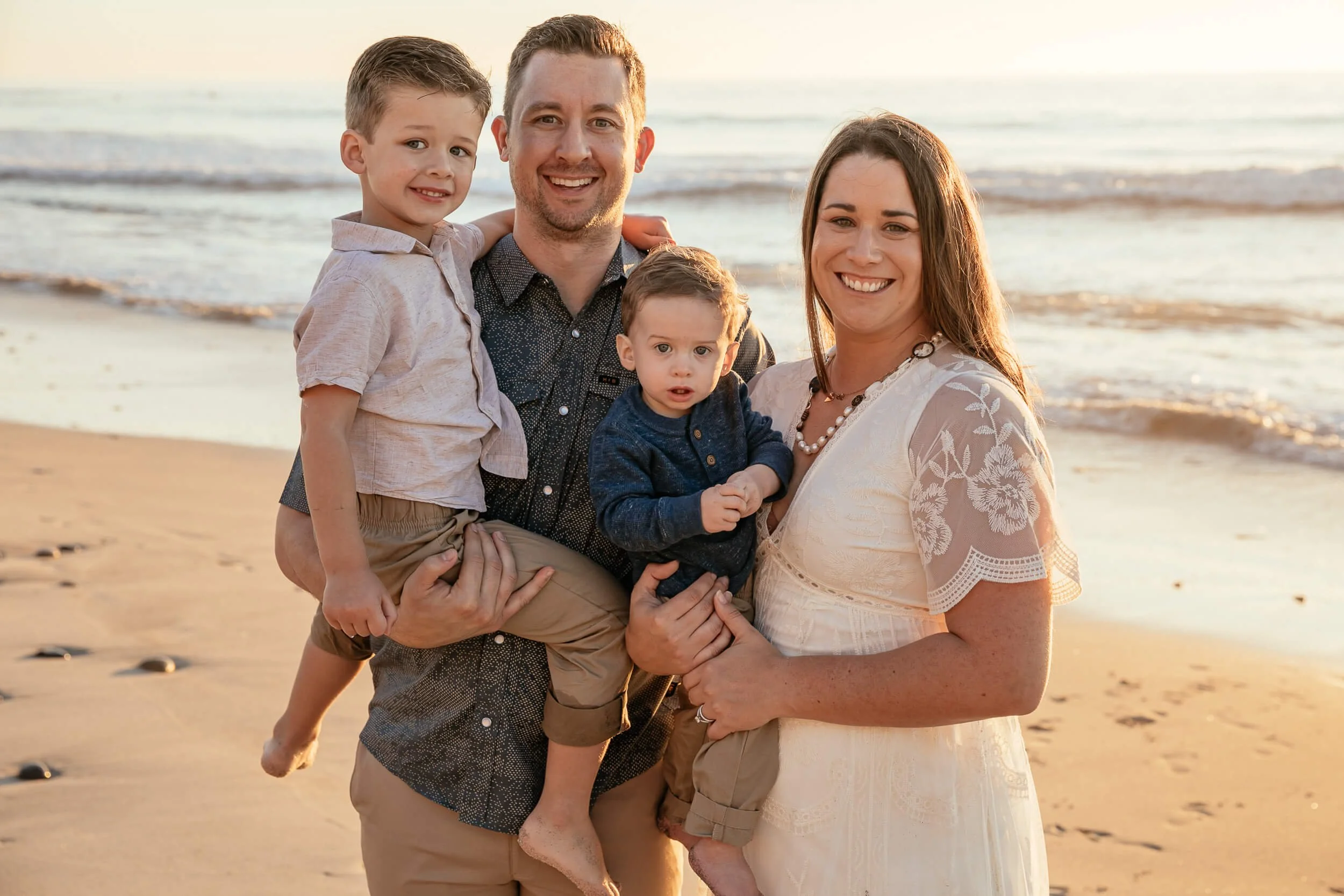 Family beach portrait photographed during sunset by a Carlsbad wedding photographer