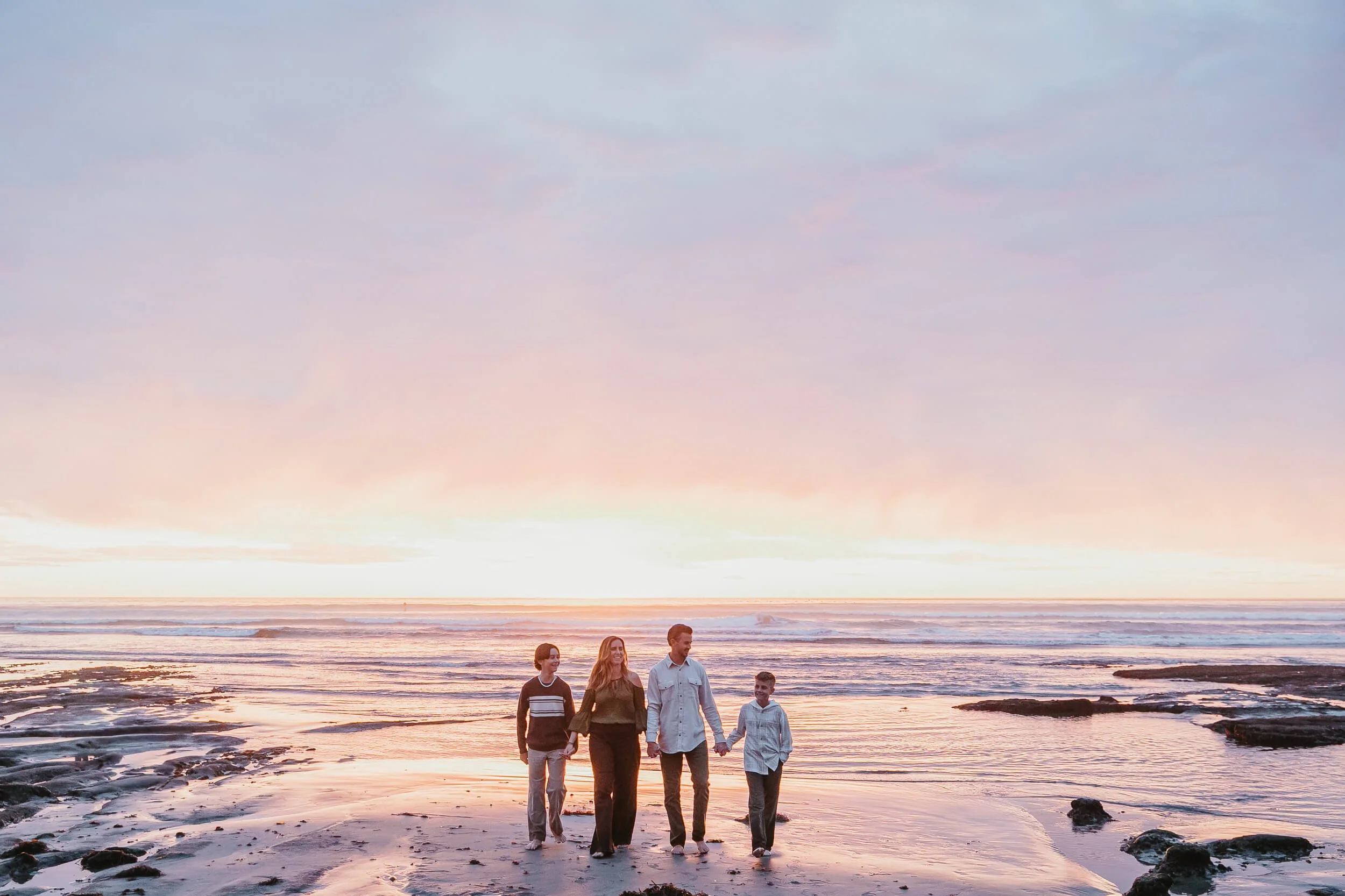 Family portrait at sunset by the ocean photographed during a Carlsbad Beach Family Photography Session