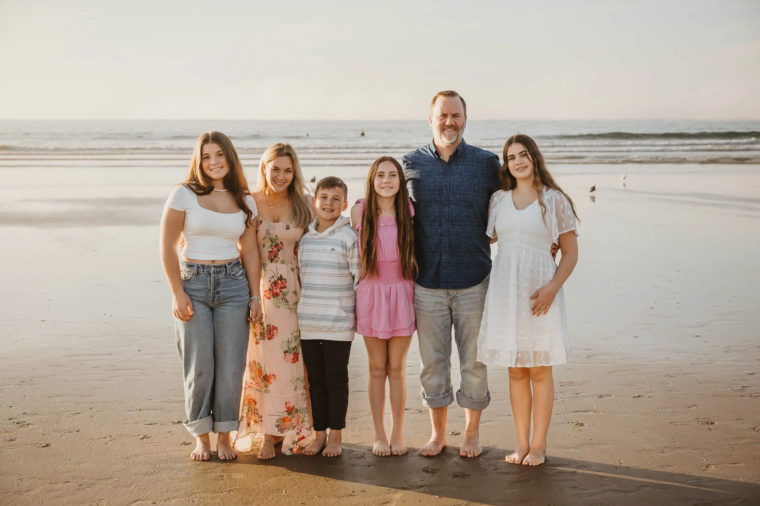parents and kids smiling for picture at La Jolla Shores beach during San Diego mini session 