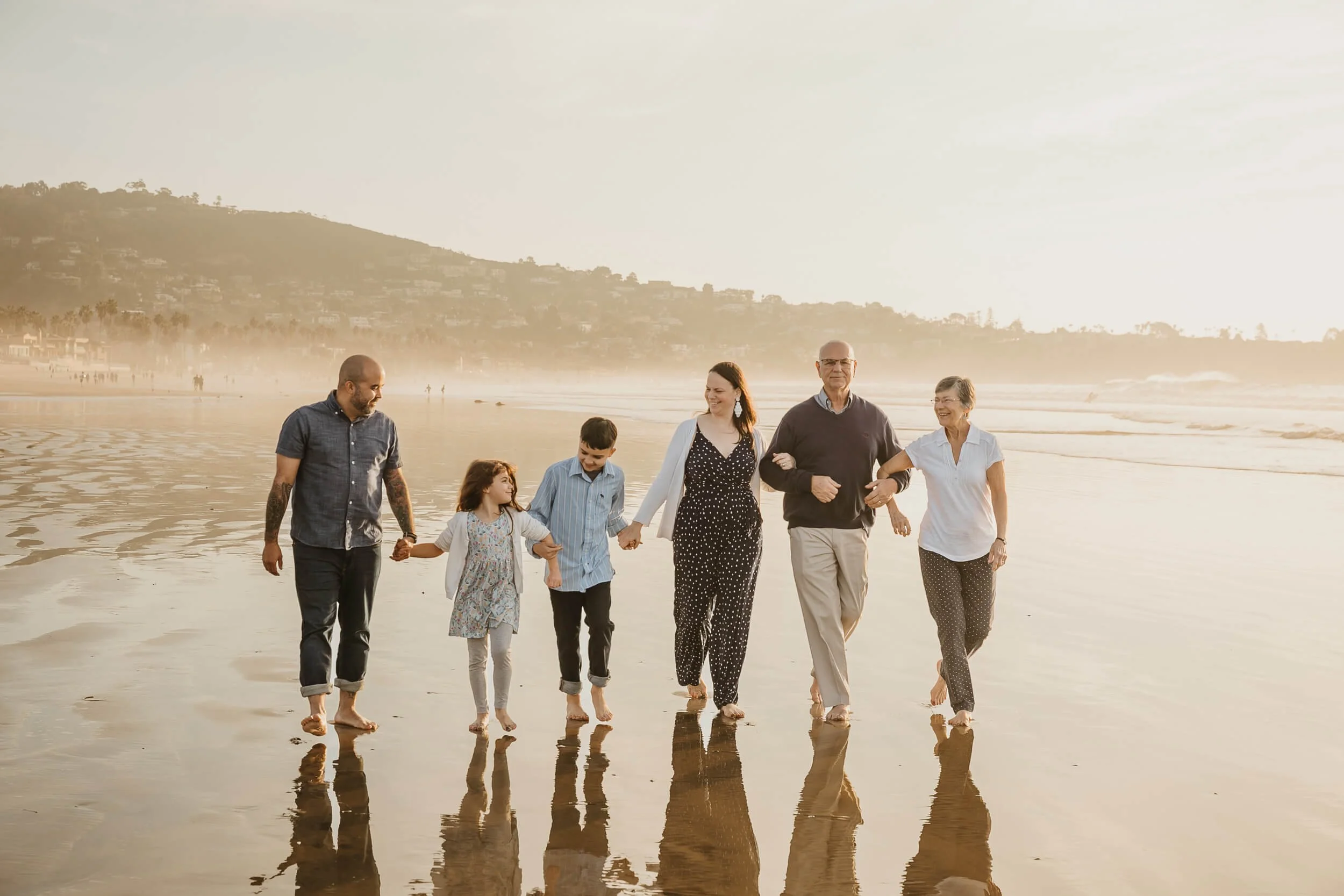 Family and grandparents having fun walking on shoreline for La Jolla Shores and Scripps Pier Family Photography in San Diego