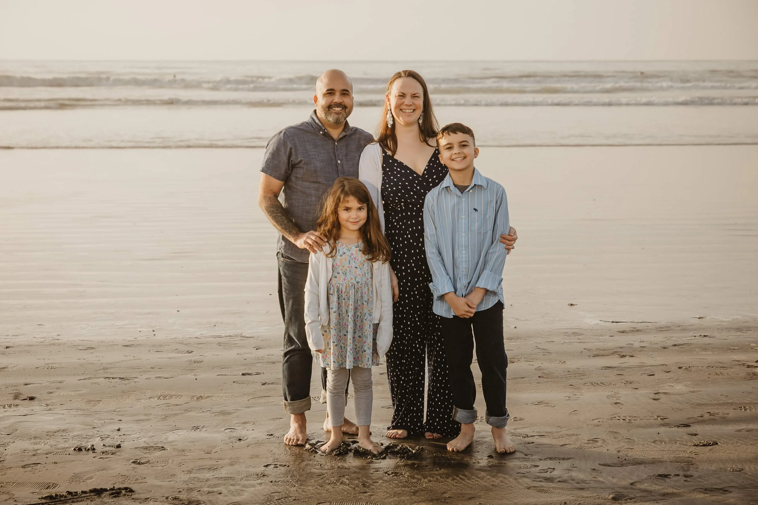 Family of four at La Jolla shores photo session posing and looking at camera with smile 
