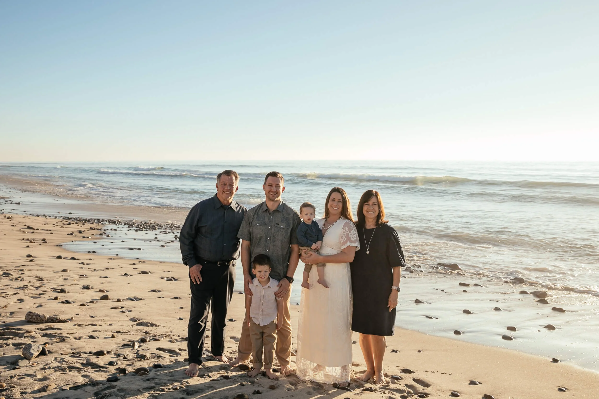 Family portrait by the ocean during sunset in Carlsbad, California