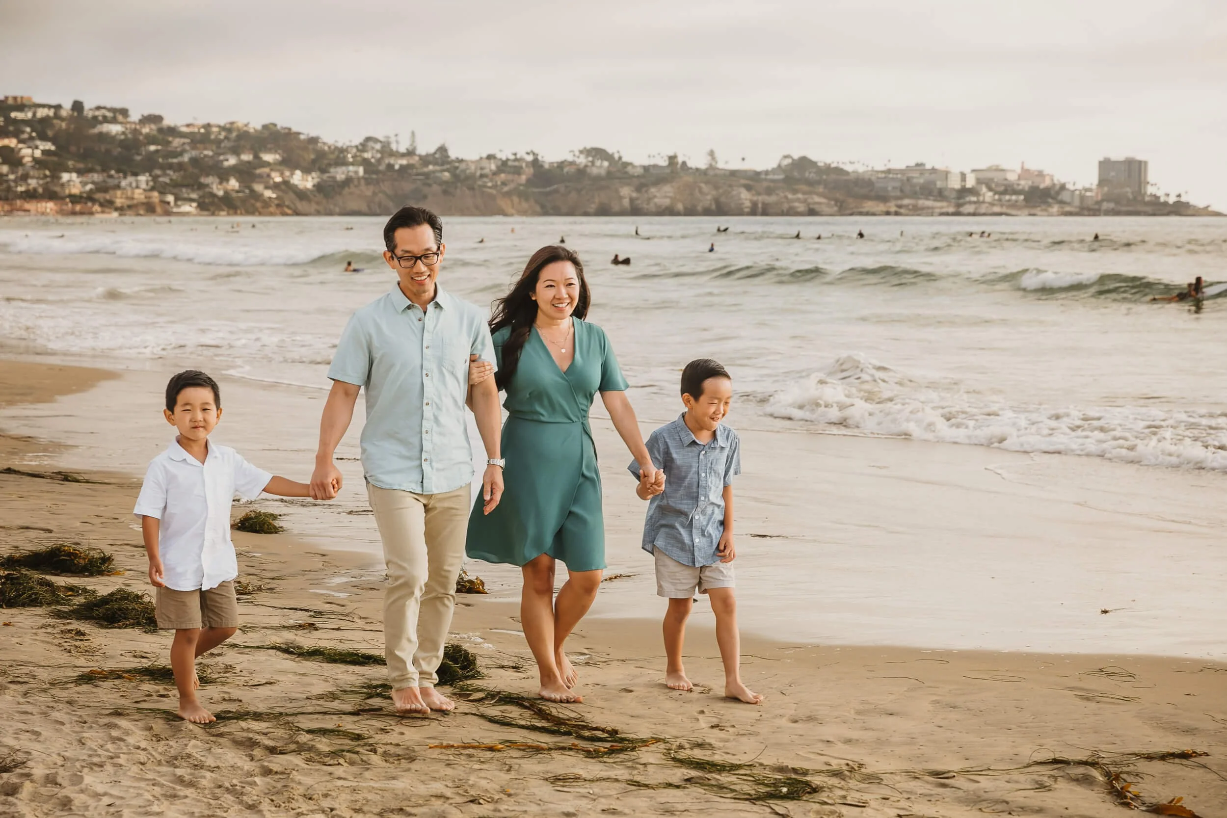 Casual and candid photo of family of four during La Jolla Shores and Scripps Pier Family Photography in San Diego