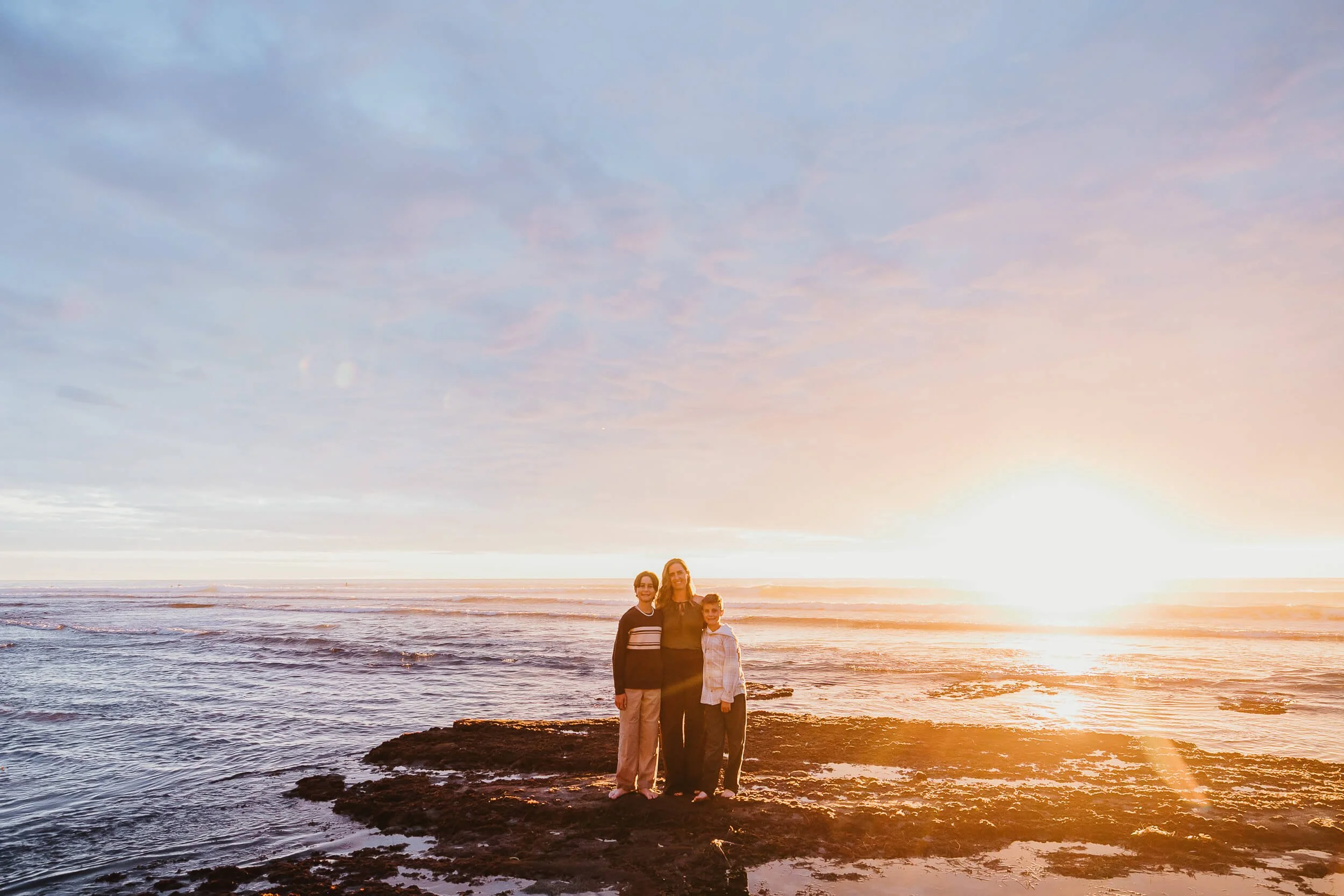 Sunset family portrait standing on tide pools during a Carlsbad Beach Family Photography Session