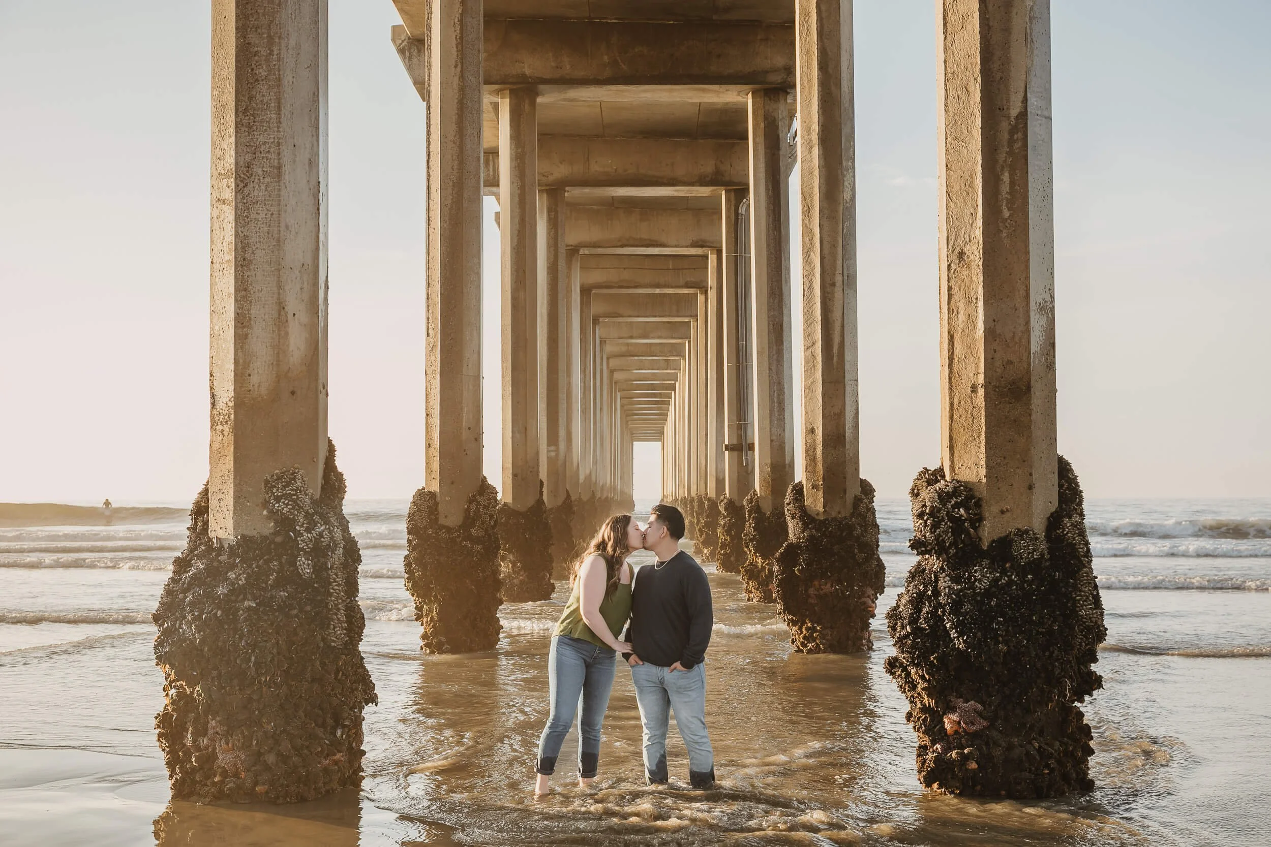 Couple kissing during the low tide at La Jolla Shores and Scripps Pier Family Photography in San Diego