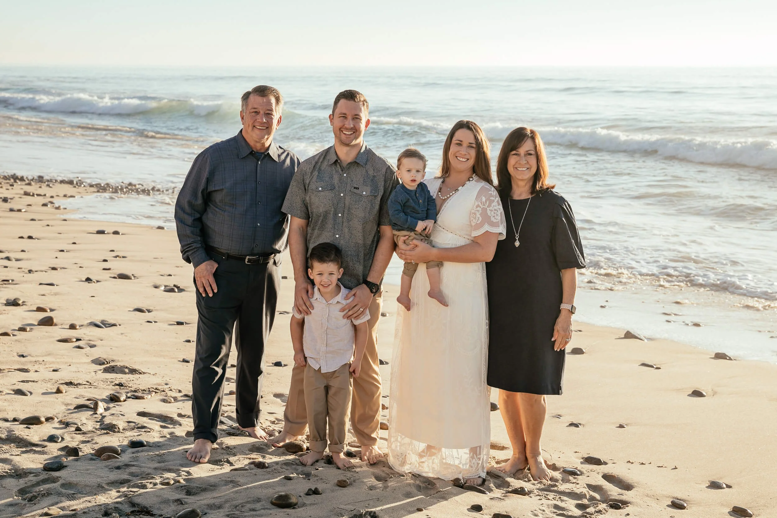 Multi generational beach family portrait photographed by a Carlsbad wedding photographer