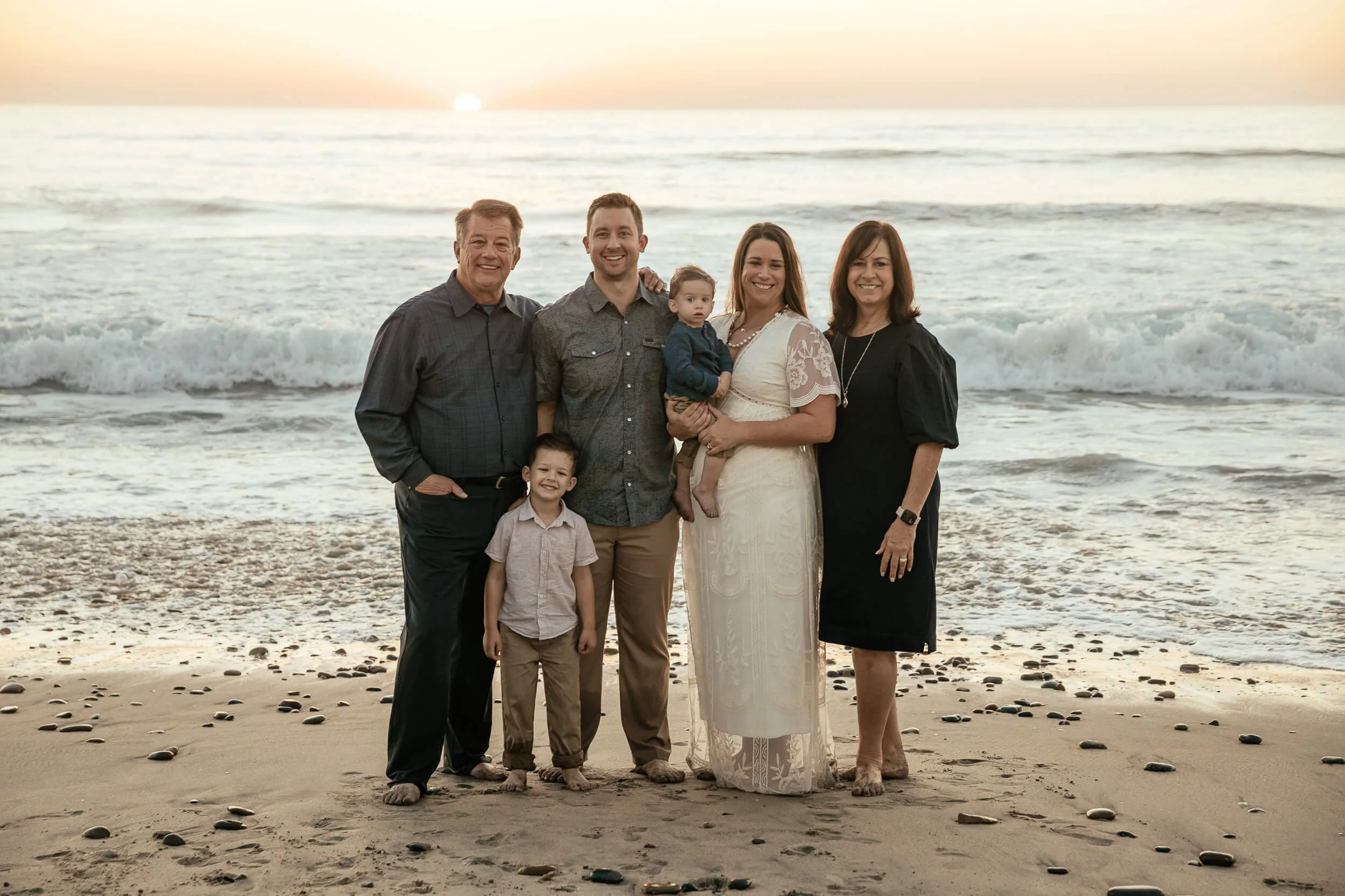 Family portrait by the ocean at sunset during a Carlsbad Beach Family Photography Session