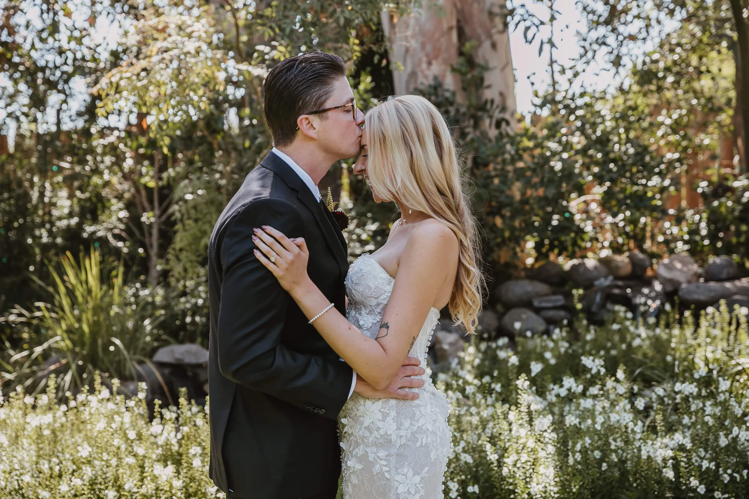 Bride and groom kiss during Twin Oaks House & Gardens Estate Wedding photographed by San Diego wedding photographer