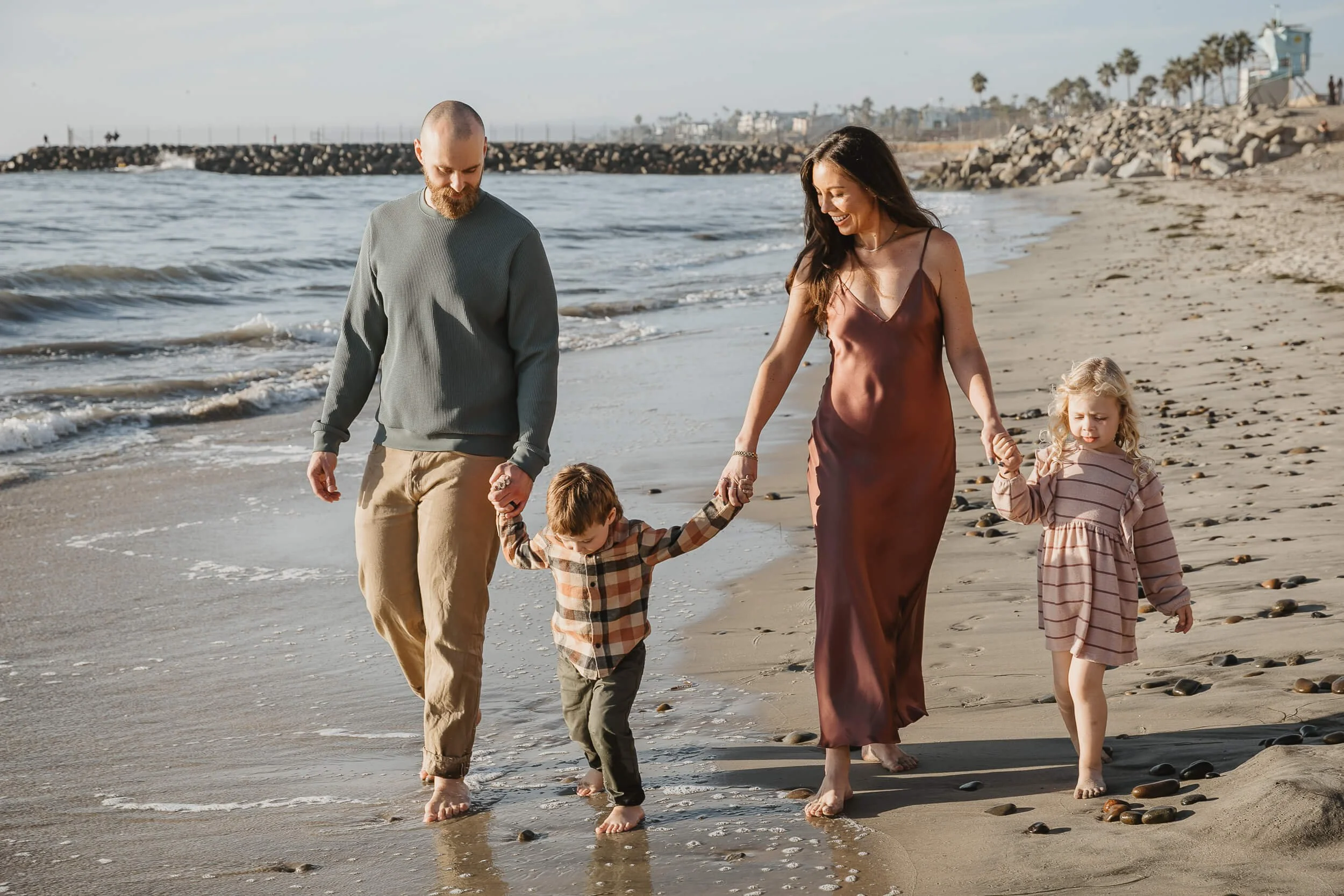 Family enjoying a sunset beach session in Carlsbad photographed by a Carlsbad wedding photographer