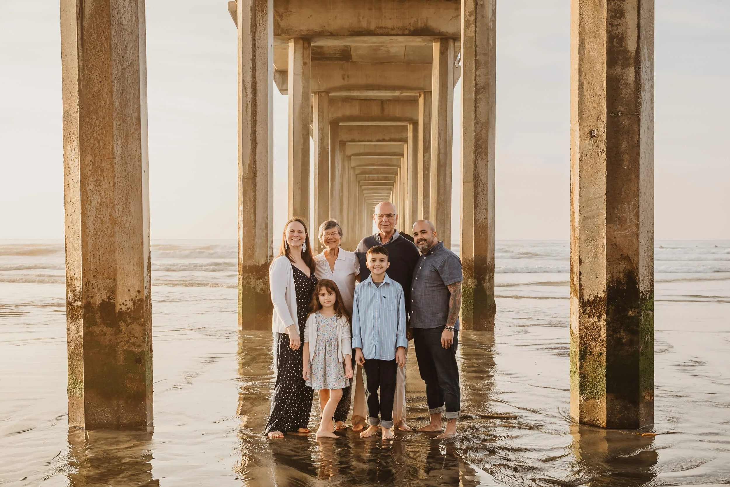 San Diego mini sessions full family under the Scripps Pier during sunset golden hour for family portrait session 