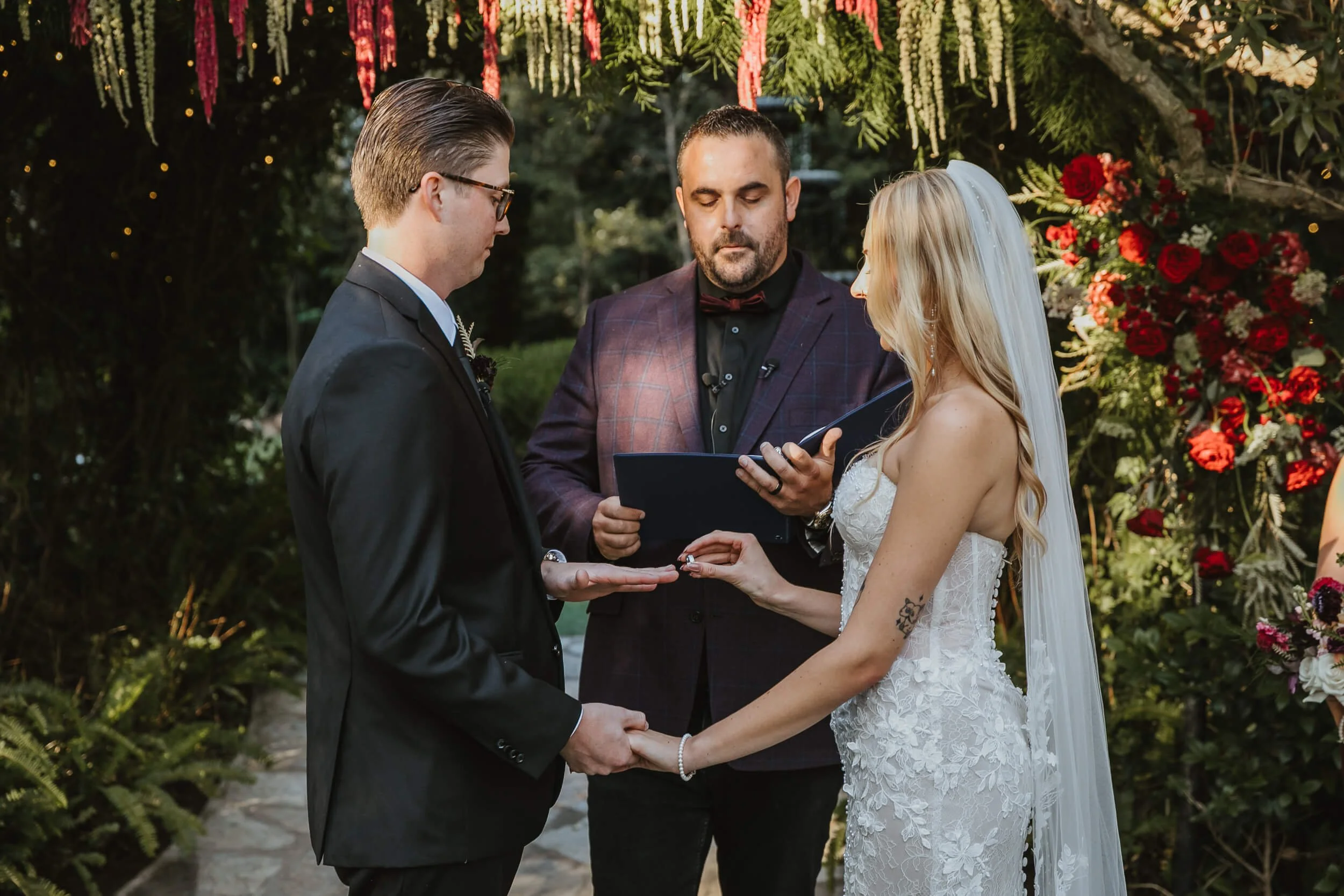Bride and groom exchanging rings at Twin Oaks House & Gardens Estate Wedding in North County San Diego