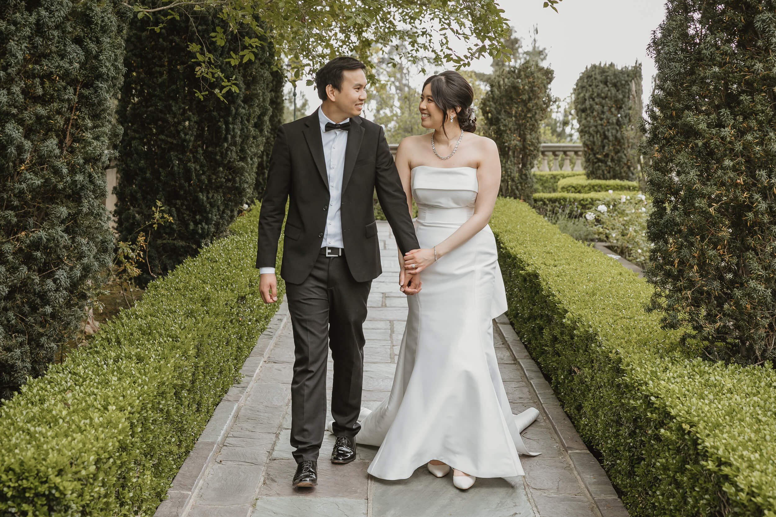 San Diego engagement photographer at Greystone Mansion and Gardens Beverly Hills couple walking while looking at each other