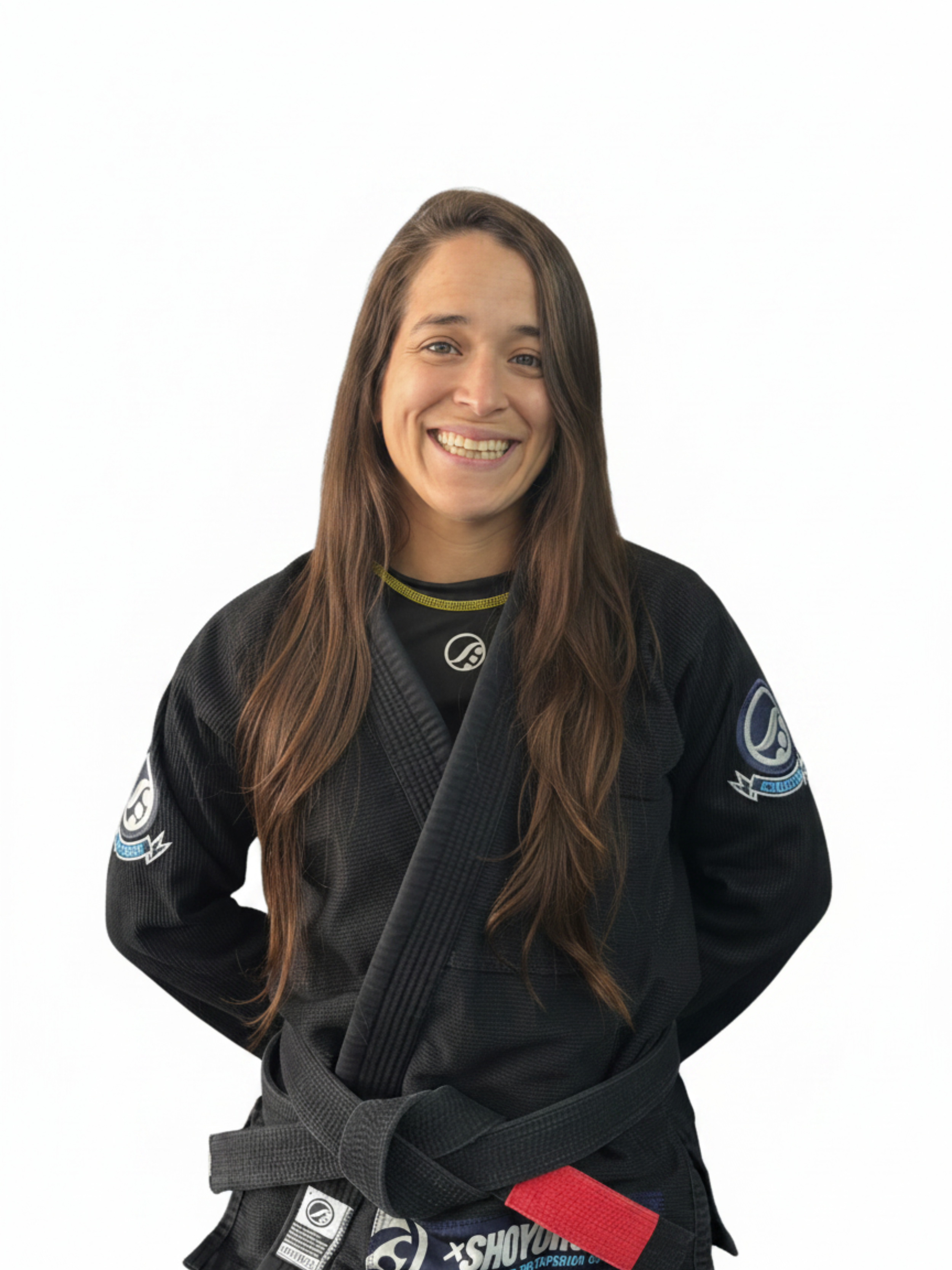 A young man with dark hair and light skin wearing a blue judo uniform, smiling softly, with a plain white background.
